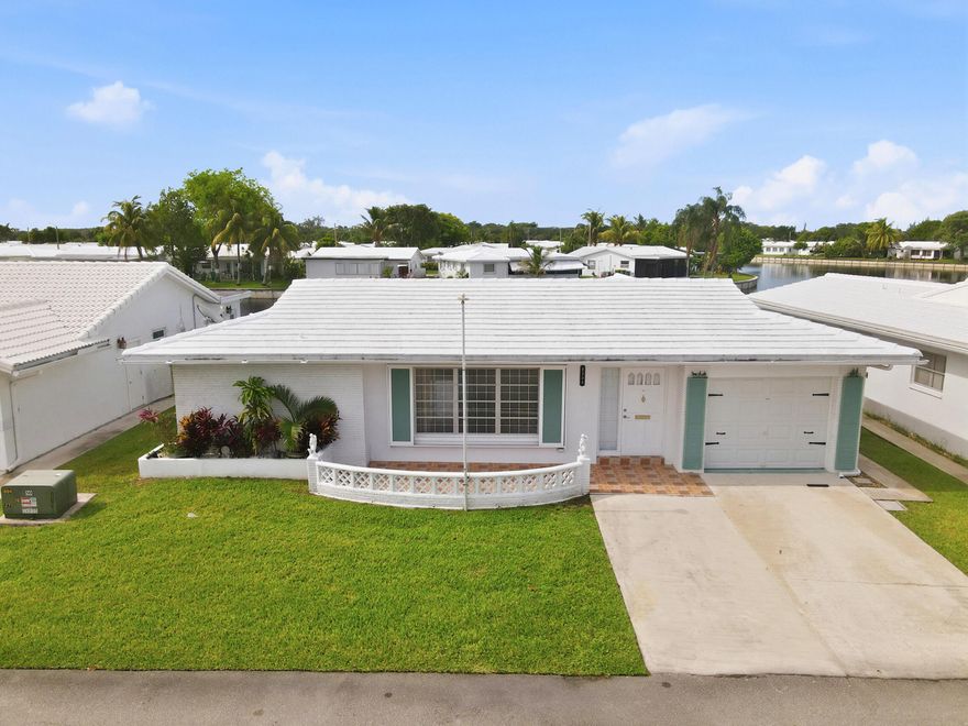 Don't miss this rare opportunity to own one of the largest homes in the sought-after 55 plus community Mainlands of Tamarac Lakes! This expansive 2 bed, 2 bath split bedroom plan offers 1,700 sq ft of living space, enclosed FLA room & 1 car garage w/2 parking spaces all ideally positioned on a beautiful waterfront lot. Enjoy the Sunrise & sunset all in one day while sipping your morning coffee or dining al fresco. Notable features include freshly painted interiors, laminate wood floors, tankless water heater, upgraded electrical panel & add'l enhancements throughout. This move-in ready charming home presents exceptional potential for personalization. Combined with low maint. fees & outstanding community amenities, this waterfront property is priced to sell at an extraordinary value!