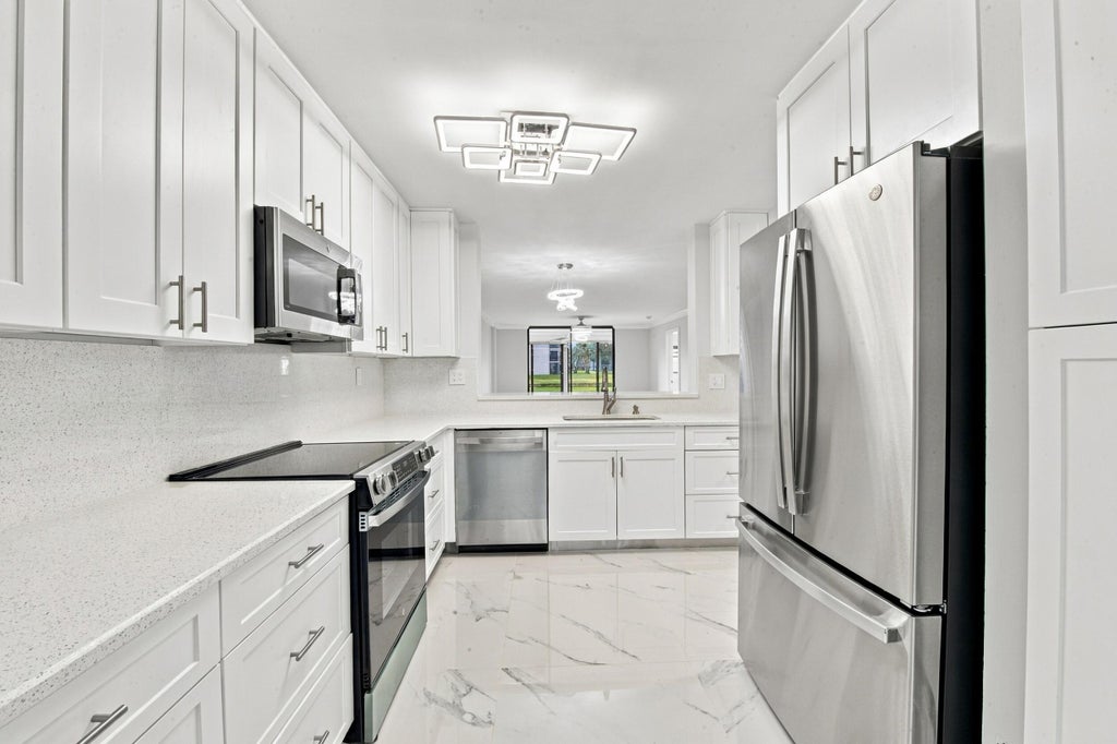 Photo of 15324 LAKES OF DELRAY Boulevard #105, Delray Beach, FL 33484 (MLS # B26090009)