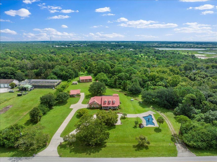 4.6-Acre Estate Compound Welcoming Family, Guests, and Even 4.5 Horses! Welcome to a property that feels less like a house and more like a legacy. Custom-built entirely from 100-year-old reclaimed Chicago brick, this estate combines the warmth of rustic craftsmanship with the comfort and functionality today's lifestyle demands. The main residence offers 5 bedrooms plus a loft across a split floor plan wrapped in character--real Hickory wood floors, vaulted ceilings, and the natural beauty of historic brickwork throughout. A commercial-grade kitchen anchors the home, while essentials like a metal roof, impact windows, new A/C, and a backup generator ensure peace of mind without sacrificing charm. Out back, the setting feels like a private resort: a gas-heated pool and hot tub,