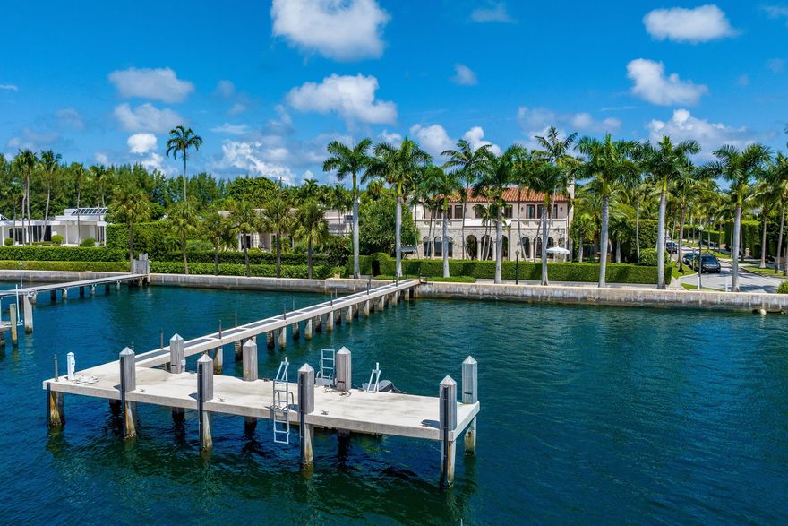 Beautiful In-Town, Lakefront home as seen in Architectural Digest. This gorgeous Mediterranean Villa features stunning water views, Lake Trail access, and Intracoastal boat dock. With interior design by AD100 designer, Martyn Lawrence Bullard, this estate has been beautifully updated with light and bright interiors and spectacular architectural details throughout. Fantastic outdoor living spaces including large interior courtyard with outdoor fireplace, columned loggia with commanding views of the Intracoastal waterway, summer kitchen, and serene pool area with gorgeous tropical landscaping. Entry foyer leads to formal living room with pecky cypress ceilings and coral stone fireplace. Grand Owner's Suite with dual bathrooms, sitting room, and two oversized lake facing balconies. Additional interior highlights include formal dining room, family room with built-ins, and beautiful gallery that leads to guest suites. Gourmet eat-in chef's kitchen with top-of-the-line appliances and breakfast room with fireplace. This home exemplifies the highest standard in craftsmanship and no detail has been overlooked.