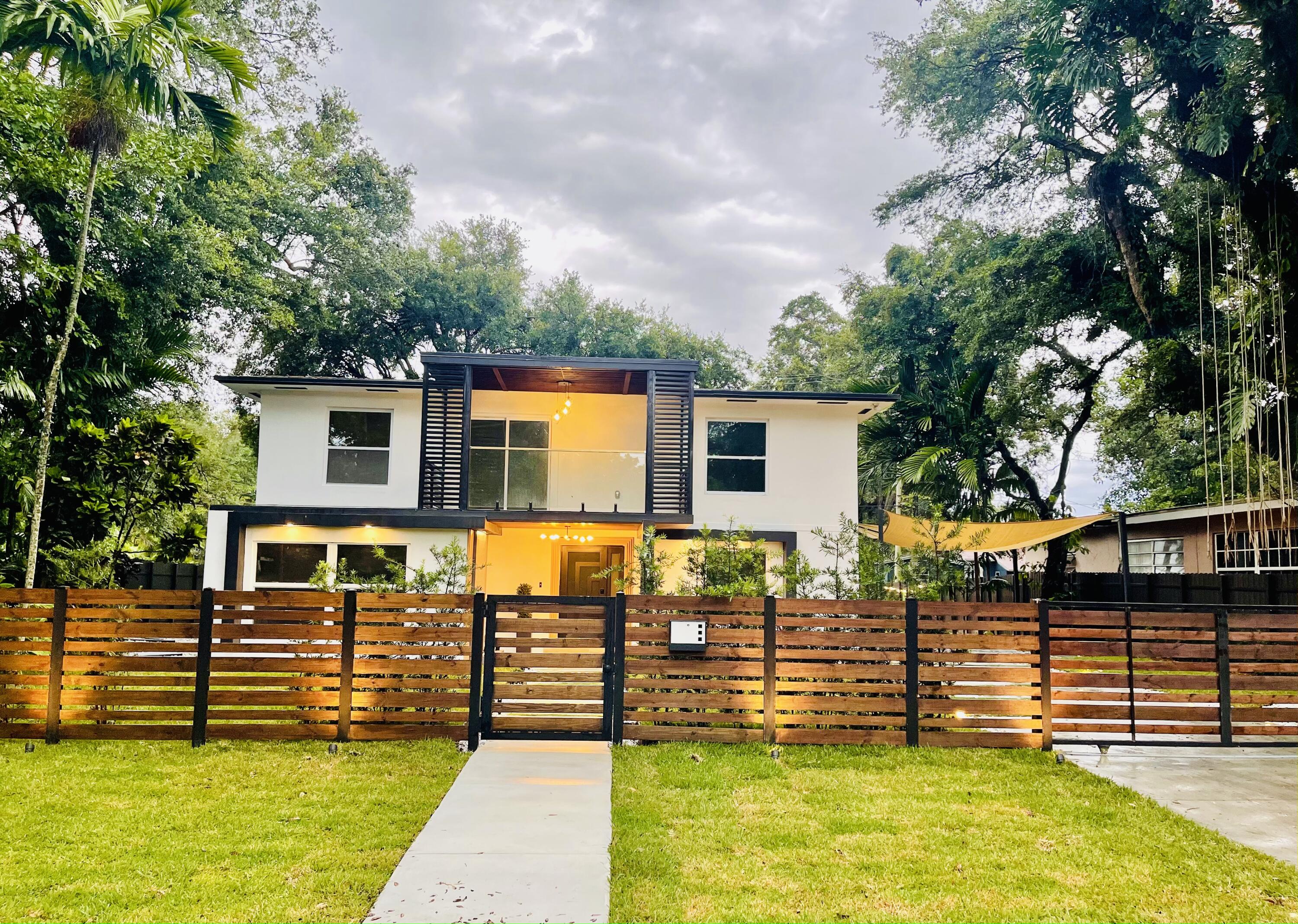 MUST SEE!! This newly remodeled two-story house is located on a quiet street in North Miami Beach. Minutes away from major highways I-95, Turnpike, Palmetto, Excellent opportunity for Airbnb at unincorporated Miami Dade County. Corner property with access from both streets and no HOA. This 3 beds 3 baths home features an open concept kitchen with a big island, quartz countertops, stainless steel appliances, hurricane impact windows and doors, new AC, new tile flooring, glass staircase, waterfall entrance accent. Main bedroom with a resort style bathroom, marble floors and a large covered balcony with glass railing. Smart house technology including Ring doorbell