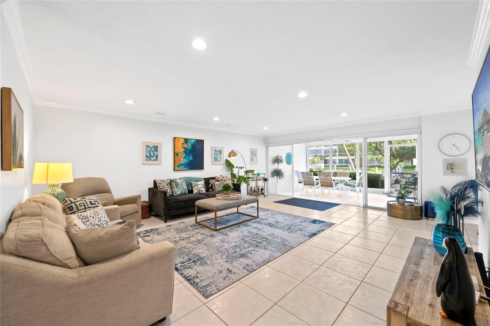 Spacious ground-floor condo just minutes from downtown Lauderdale-by-the-Sea and the beach! Enjoy a large screened balcony with peaceful canal views. The open living area flows into a separate dining space, perfect for entertaining. Open kitchen concept with granite countertops and matching white appliances. The master bedroom features a generous walk-in closet and ample room. Second bedroom has ample space and Jack-and-Jill bathroom adds convenience. Matching tile flooring throughout. In-unit newer washer and dryer make daily living easy. Includes two assigned parking spaces. Community offers great amenities—two pools, dock space, and a fitness center. Ideal for those seeking comfort, location, and coastal living wihtout the hefty price tag.