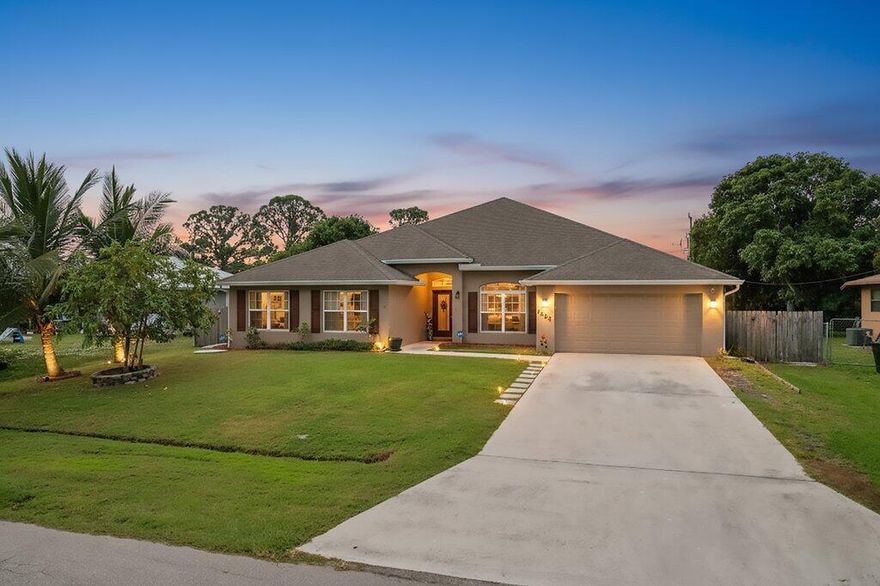 Immaculate 4-bedroom, 3-bath CBS home offering over 3,000 sq ft of living space in the desirable Port St. Lucie Lyngate area. From the moment you enter, you are welcomed by a spacious open floor plan with vaulted ceilings and beautiful natural light. The chef-inspired kitchen features upgraded cabinetry, a large center island, breakfast bar, and a butler's pantry that provides exceptional storage and convenience. The primary suite offers a relaxing retreat with dual sinks, a soaking tub, and a separate walk-in shower. The split-bedroom layout adds privacy for guests or family. Step outside to a fenced backyard with multiple tropical fruit trees, creating a peaceful outdoor oasis with room to add your dream pool.