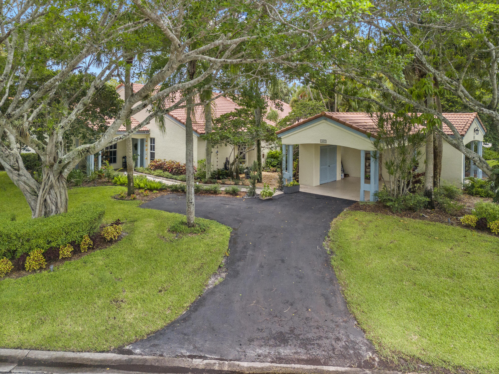 Welcome to this beautifully appointed residence in coveted Las Casitas enclave of Palm Beach Polo & Country Club. Situated on one of the largest corner lots, this fully remodeled home offers a rare combination of luxury, comfort, & privacy--along with tranquil water views.Step inside to discover an open floor plan w/custom finishes throughout. The kitchen is a chef's dream, featuring new white cabinetry, an expansive island perfect for entertaining, and top-of-the-line Thermador appliances. Wood-look tile flooring flows seamlessly throughout the home, complemented by all-new hurricane impact windows/sliders. Split bedrooms provides optimal privacy, w/fully renovated bathrooms that exude spa-like sophistication. Newly resurfaced pool & upgraded paver patio, plus retractable awning for shade