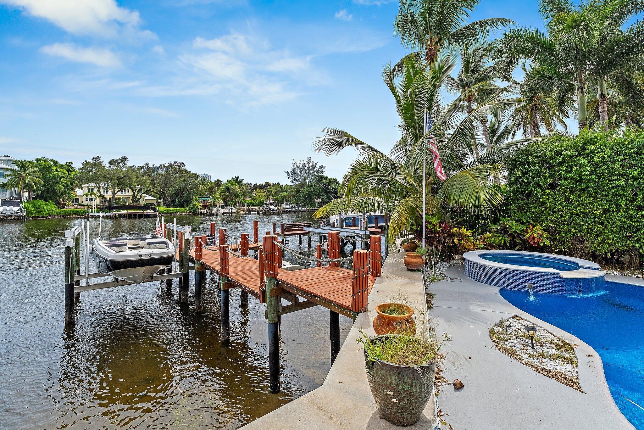 Located in the luxurious gated community of Prosperity Harbor, this stunning 4 bedroom + office, 4.1 bathroom, 2-car garage waterfront home offers the ultimate Intracoastal lifestyle. Featuring your own boat lift and jet ski lift, this residence is designed for both relaxation and entertaining. The main level boasts a spacious office/den, formal dining, and open living areas connected to the kitchen looking towards the water. Upstairs, the primary suite includes three walk-in closets and spacious bathroom, with three additional bedrooms and baths providing ample space. Enjoy direct Intracoastal access plus community amenities including a pool and cabana with being minutes from beaches, shopping, and dining.