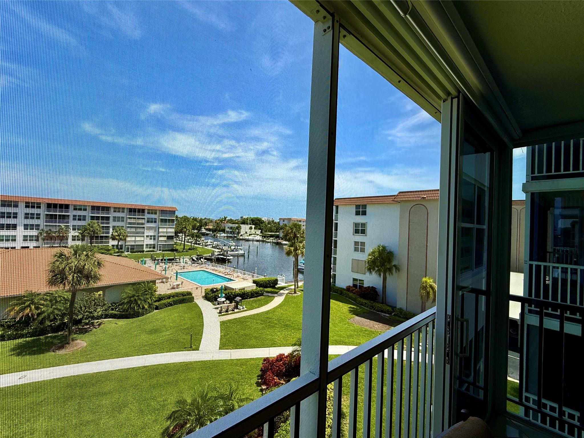 Bring your boat! Just 1.1 miles from the beach, this quiet hidden gem offers a perfect coastal lifestyle! Enjoy serene views of the garden, pool, & waterfront/marina areas. Dock your boat with easy access to ICW and ocean. Inside, find a beautifully updated condo - can be sold turn-key furnished, featuring a newer Sleep Number bed and Robb & Stuckey furnishings (also available partially furnished or unfurnished). Enclosed patio expands the under air sf. Impact windows/doors, tankless w/h, 2017 AC, crown molding, plantation shutters, automatic blinds add style and peace of mind. Spacious primary suite includes walk-in closet. Updated kitchen/baths complete the package. Amenities include covered parking spot (#19), extra storage, laundry, clubhouse, fitness center, and so much more!