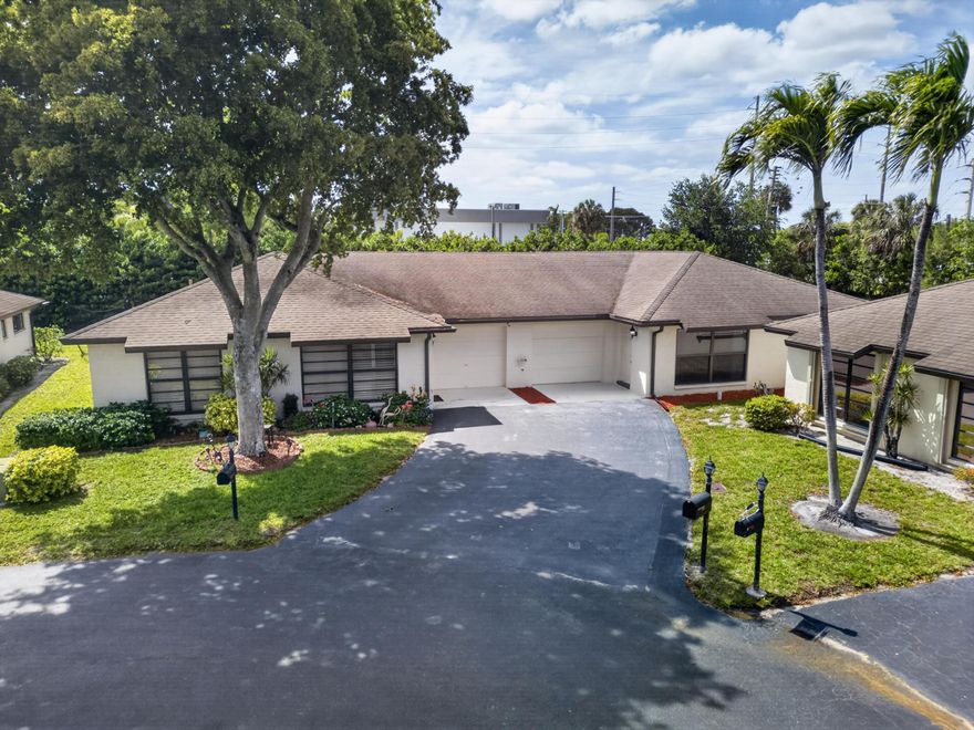 Remodeled corner 2/2 villa in the sought-after 55+ community of GreenTree Villas in Boynton Beach! This move-in ready home features wood plank flooring throughout, a spacious primary suite with walk-in closet, and a remodeled primary bath with a new shower. Impact windows and doors throughout! The kitchen is upgraded with white cabinets, granite countertops, and stainless steel appliances. Enjoy outdoor living with a new electric retractable awning in the backyard, perfect for relaxing in the shade. Roof is only 7 years old and covered by the HOA. AC is 2004. Community amenities include 2 pools and a clubhouse. HOA also covers water, cable, and internet , Just pay electric! Great location near shopping and restaurants. Hurry, this one won't last!