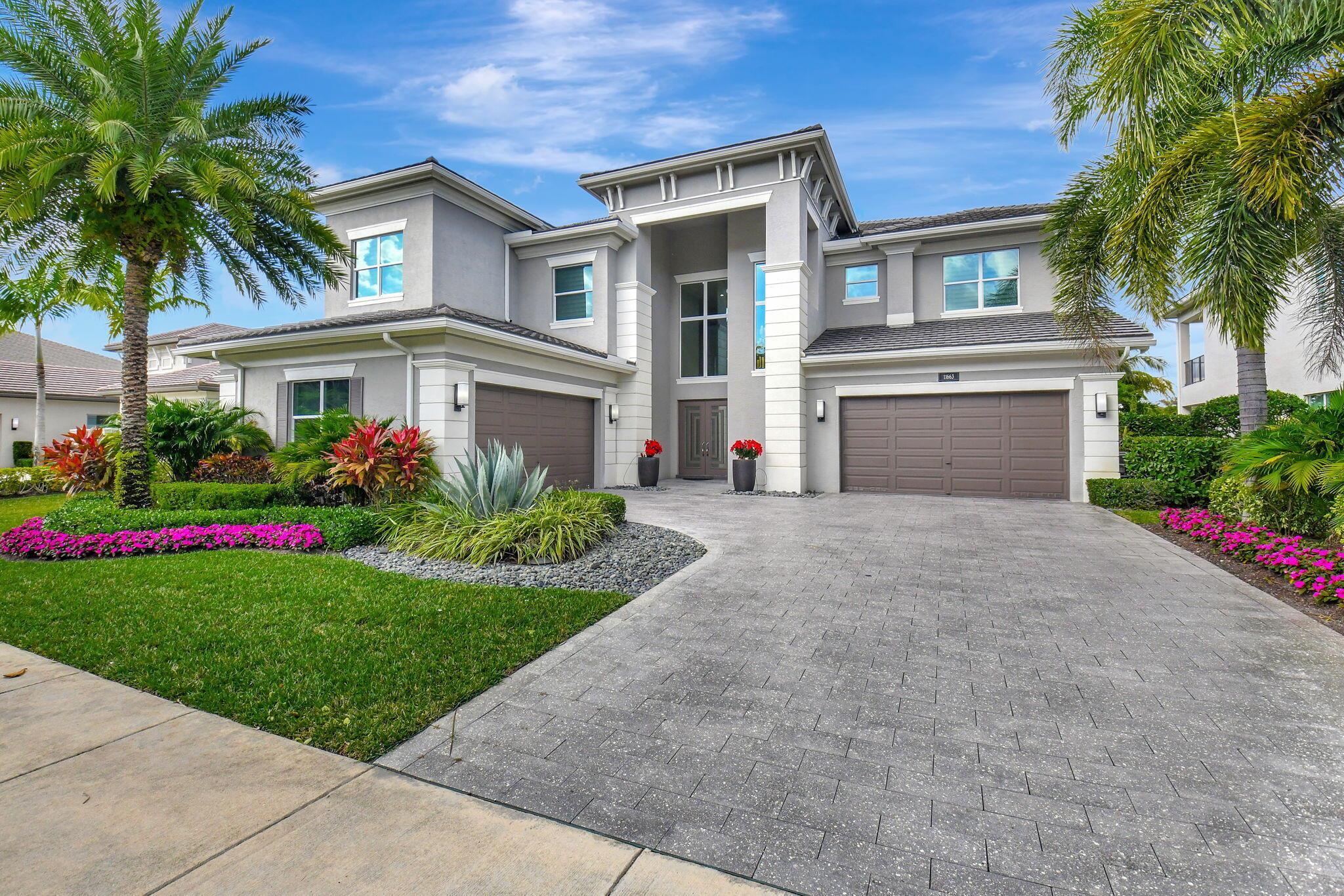 Enter into elegance with this Riverside model home, featuring superb upgrades and a breathtaking entrance with porcelain flooring. Situated on the best lot in Berkeley, this home offers a full waterfront view with five bedrooms and five-and-one-half baths. On the first level enjoy a regal dining room, a guest room with an ensuite, chef's kitchen equipped with a Sub-Zero refrigerator, Wolf gas cooktop, and a quartzite countertop on a huge island and dining area. Floor to ceiling glass enclosed wine rack. The family room boasts custom shelving, wallpaper, and accents. A customized tranquil club room features a full bar with amenities, custom seating, and remote-control shading. The outdoor area includes a summer kitchen with two grills, heated saltwater pool and spa, perfect for unwinding