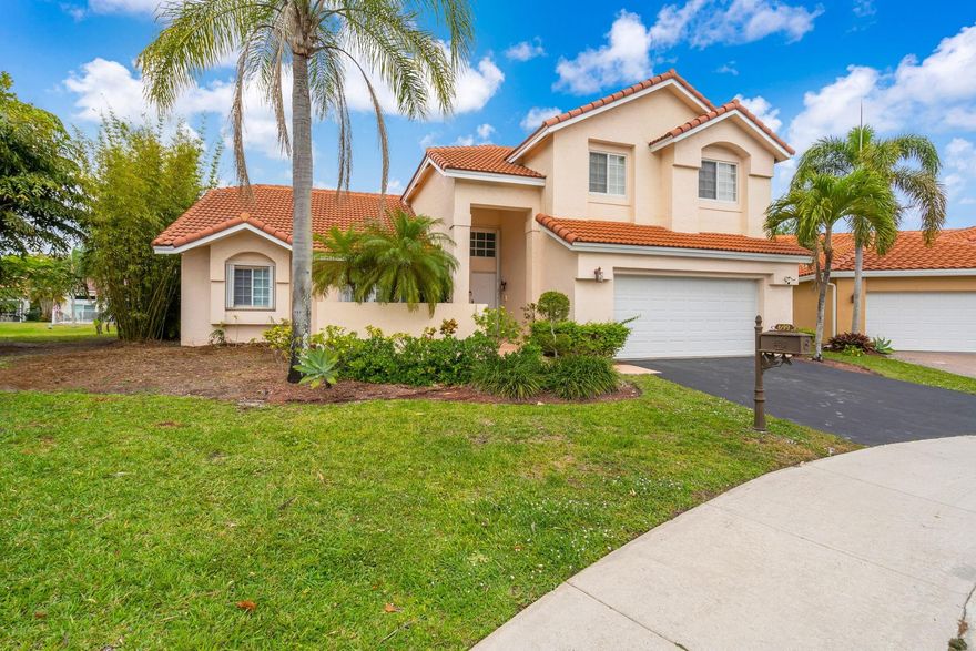 **Just reduced to 905k** Welcome to your new home in Laguna Springs II in Weston. This is an Estancia model on an oversized 12,000 SF Lot, on a quiet cul-de-sac. Property located in a gated close knit community of under 100 homes. Interior has been recently updated, including all the bathrooms and the kitchen with newer appliances. House has hurricane protection including accordian shutters. There is an additional room that can used as a den, library, office or converted into a bedroom. House has a serene lake view with 150 feet of water frontage, as well as an assortment of fruit trees. Newer roof (2019) House within walking distance (<1 mile) of Chabad, churches, parks, schools and shopping centers.