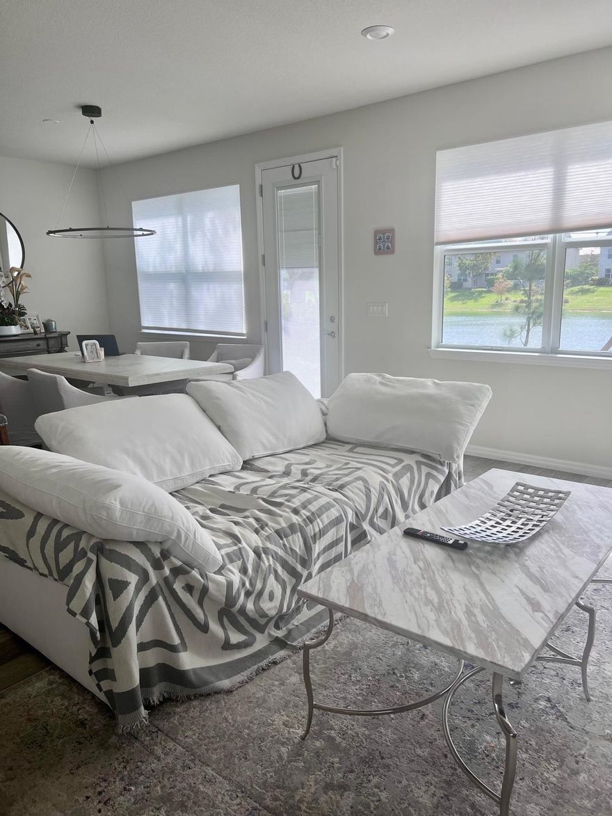 Rare Corner Townhome | Lake & Park Views | Premium Upgrades Prime centrally located corner unit directly across from the park entrance and steps to the  club house. Enjoy exceptional privacy with only one neighbor and open space on three sides. Featuring serene lake views and direct park access, this home was built with a full premium upgrade package: high-end flooring, upgraded kitchen and bath cabinetry, premium carpet, and decorative glass details. Fully equipped 2-car garage with built-in storage. Furnished option available with pieces from Restoration Hardware and Pottery Barn.