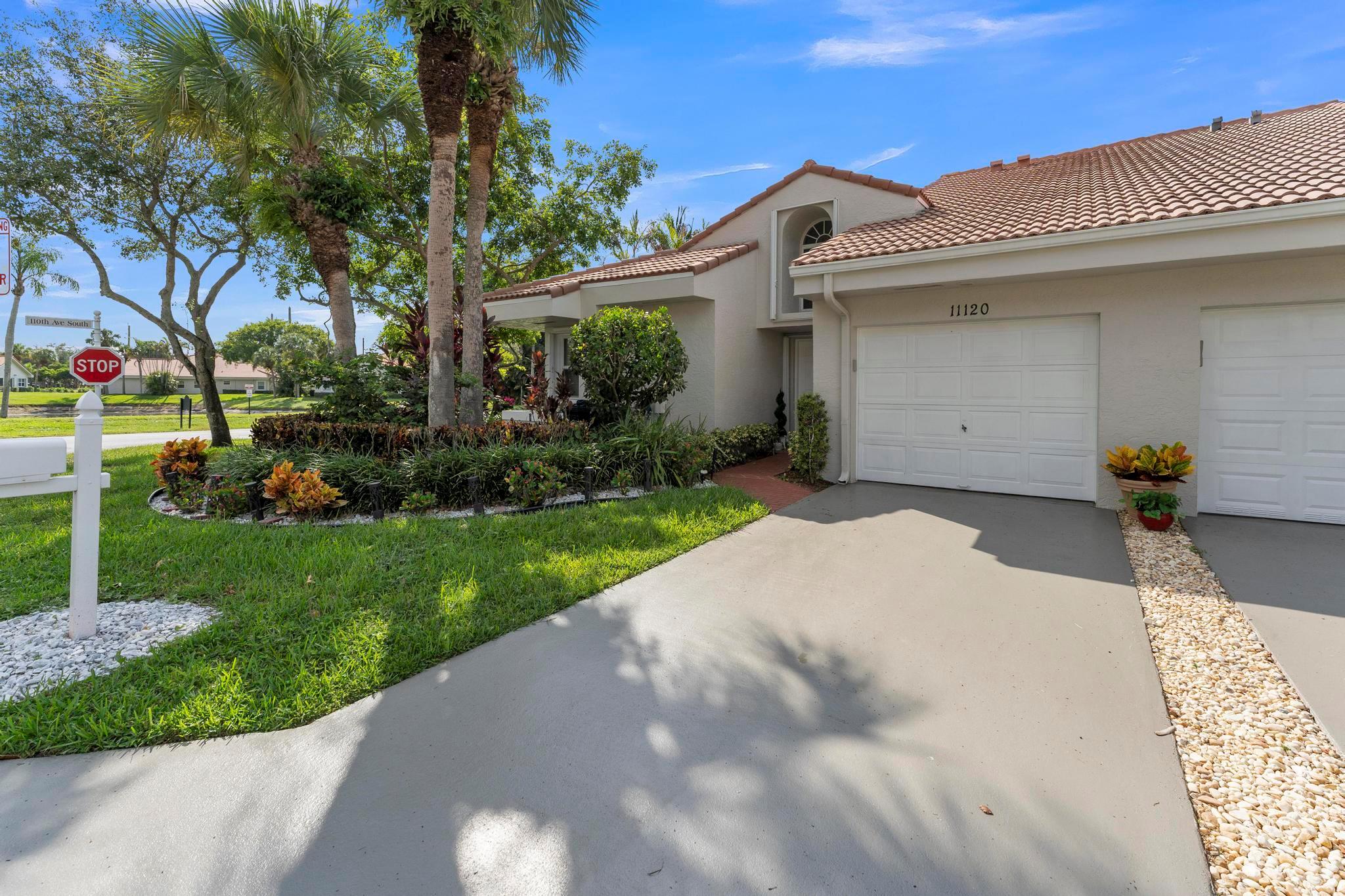 Beautifully updated and turnkey 2-bedroom, 2-bathroom villa with a 1-car garage and stunning lake view. Updates include newer kitchen cabinets with granite countertops, plantation shutters throughout, and impact glass on sliders and kitchen windows. The primary bathroom features dual sinks and granite countertops. Enjoy newer bathroom vanities, tile wainscots, toilets, wood and tile flooring, light fixtures, and hardware throughout. Vaulted ceilings and large windows add character. The owner offers a 1-year guarantee on all appliances. The front yard is professionally landscaped. Includes a pantry, his and her closets, and a coat closet. The roof is from 2024. Enclosed patio area with lake view. 55+ community close to shops, highways, and entertainment.