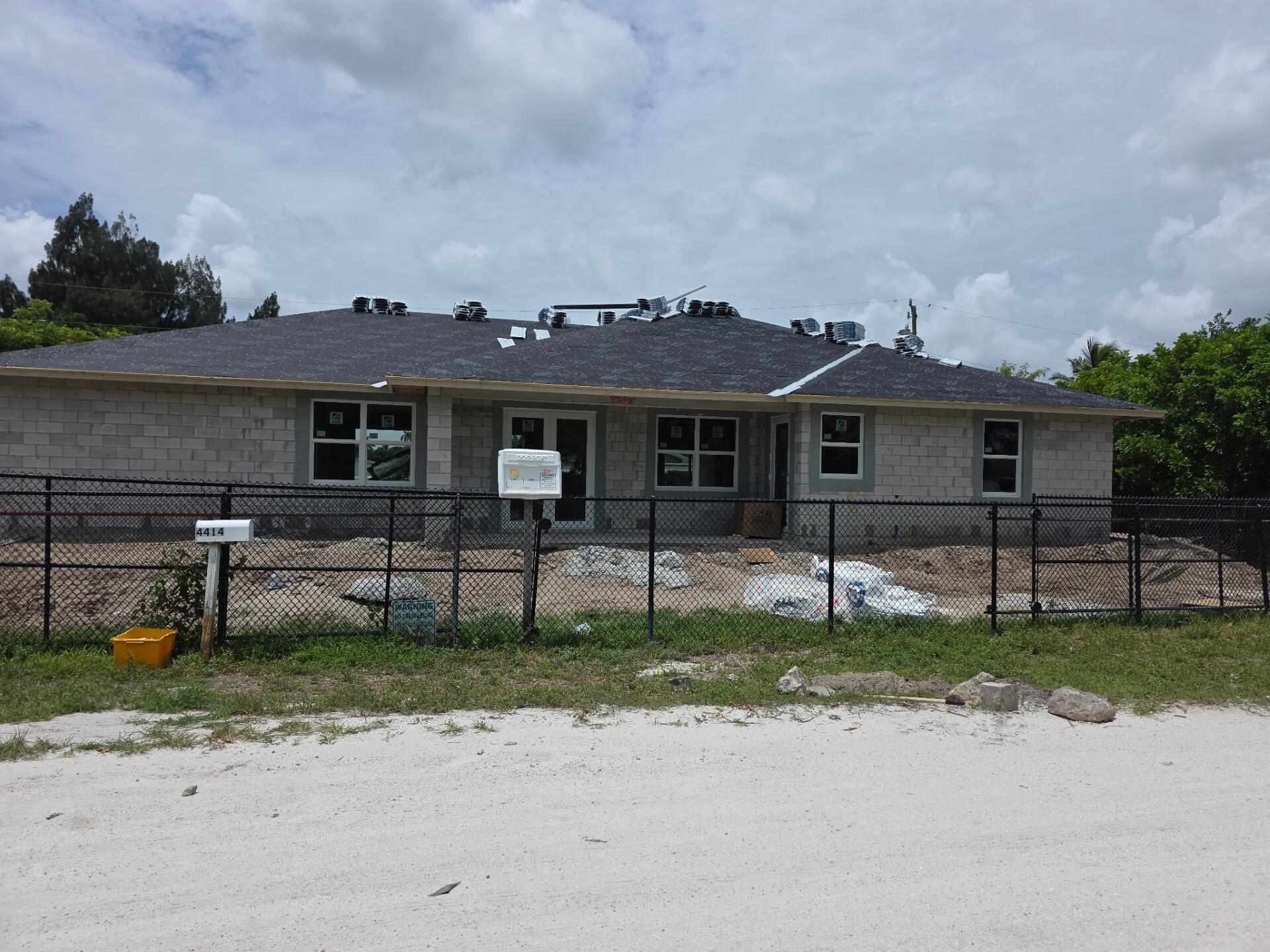 THIS HOME IS UNDER CONSTRUCTION. THE HOME FEATURES PORCELIAN TILE THROUGHOUT, THE KITCHEN CABINETS ARE ALL WOOD SELF CLOSING WITH QUARTZ CONTERTOPS. THE HOME FEATURES FOR BEDROOMS AND CAN EASILY FEATURE A MOTHER IN LAW SUITE WITH TWO FRONT ENTRANCES