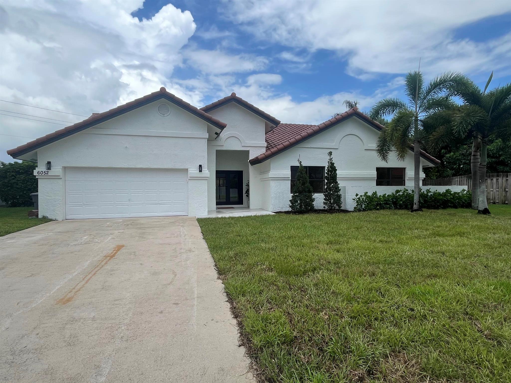 This Exquisite WATERFRONT 4-Bedroom, 2-Bathroom Pool Home sits on a Massive .46-Acre Lot that is Adjacent to a Palm Beach County owned undeveloped 6.5 Acre plot giving this homesite Unparalleled Privacy & Outdoor space within a beautiful-secure subdivision. The Entire home has been Meticulously Renovated with Modern Upgrades and Luxurious Finishes Throughout with New Features including a 2025 Tile Roof, FRESHLY Painted Interior & Exterior, Glass Double Door Front Entrance Welcoming you Into your Large, Bright, Open & Inviting Interior, with a spectacular HUGE Open-Style Living-Dining-Kitchen Space with Gorgeous Views that Overlook the Newly Refinished screen-enclosed Pool and Huge Waterfront Backyard. This beautiful Home has NEW Flooring, NEW Interior Doors, NEW Recessed Lighting