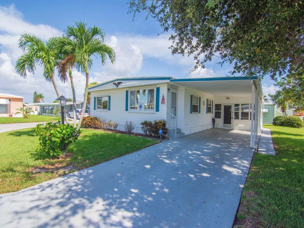 Located in the vibrant 55+ community of Pinelake Village, 264 NE Cameo Way in Jensen Beach, Florida, offers a perfect blend of convenience and charm. This beautifully maintained 2-bedroom, 2-bathroom manufactured home is situated on a desirable corner lot, providing both privacy and curb appeal.Step inside to a spacious living room and a bright and airy Florida room, perfect for relaxing or entertaining guests. The split-bedroom layout ensures privacy, while the well-appointed kitchen boasts ample storage, including a pantry. The primary bedroom offers a cozy retreat with an en-suite bathroom featuring a walk-in shower. Pinelake Village offers an active lifestyle with amenities like a clubhouse, fitness center, library, shuffleboard, and a community pool. Lot rent is $765 per month.