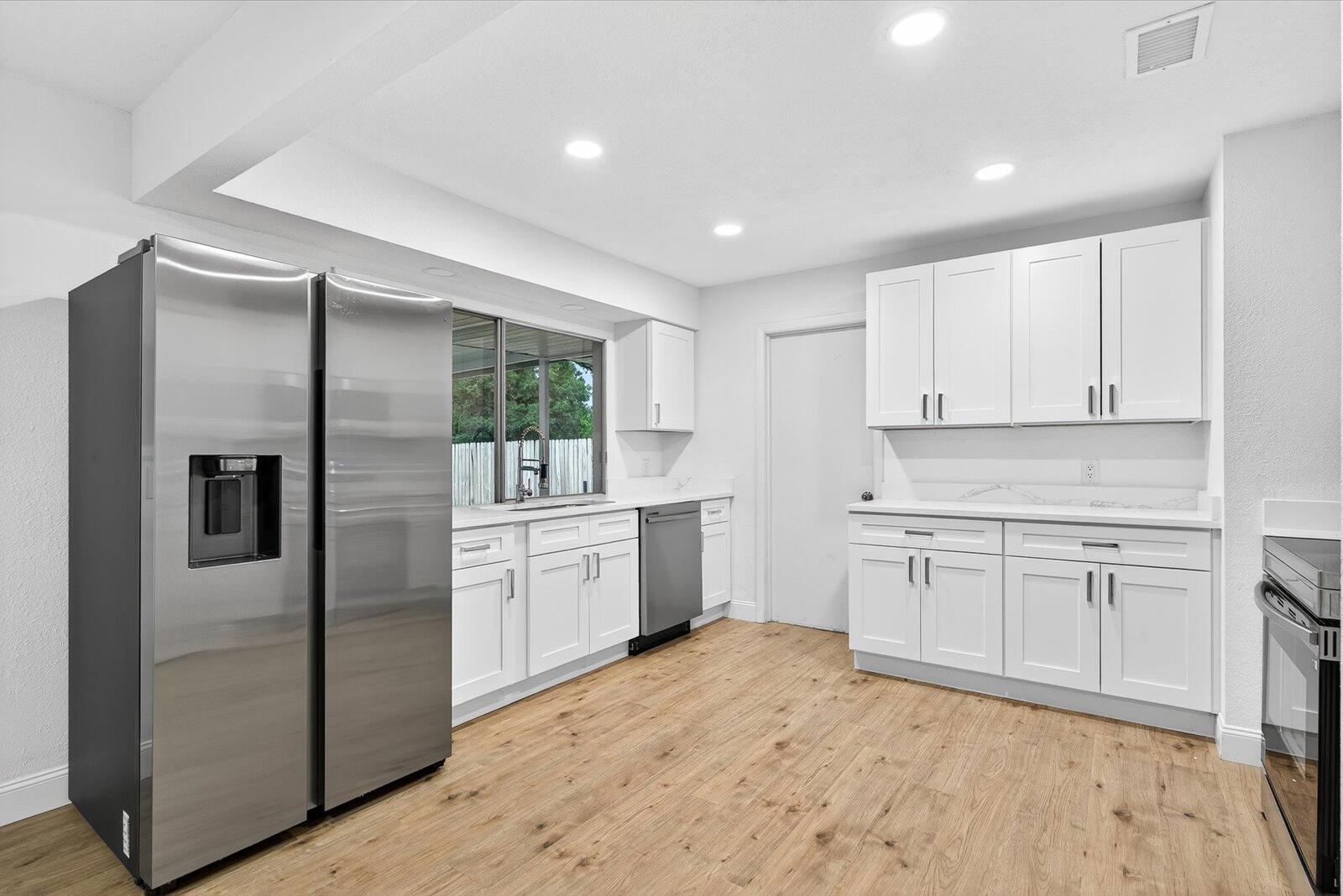 Showings must be scheduled with Showingtime or Sentri. Stunning 3/2 home remodeled in 2025 with gorgeous kitchen and bathrooms! Minutes from town and beaches. Completely move in ready. Offering new Calacatta quartz kitchen with soft close shaker cabinets and high end finishes, spa like tile bathroom with high end vanity, waterproof laminate floors, fresh paint in and out, Brand new appliances, new fixtures and landscaping. Easy access to i95 and shopping. Move in ready condition, you wont need to lift a finger. No HOA!! Come relax in this gorgeous home and live your Florida Dream! Sewer, 2022 Roof, 2025 AC.