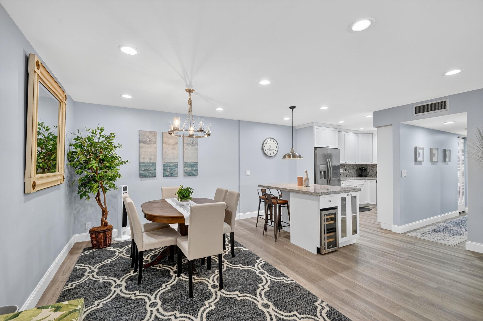 Get the Beach Vibe in this newly remodeled, and seasonally used 3BR, 2BA home in the 55+ community of Pine Ridge North Village IV. Updates include impact windows throughout and roll down shutters on the screened balcony, 2 gorgeous bathrooms, AC 2024, and roof 2024. Luxury vinyl floors in a beautiful, wood-grain complement the beach decor. The kitchen has been opened and remodeled with granite counters, white cabinets, and an island with a wine cooler, and more storage. The flow from the kitchen, dining room, and family room create an easy space for entertaining. The 3rd bedroom could be an office/den with double doors to the family room. The corner, primary bedroom has beautiful, natural light and a walk-in closet. More storage in the laundry room. OK TO RENT