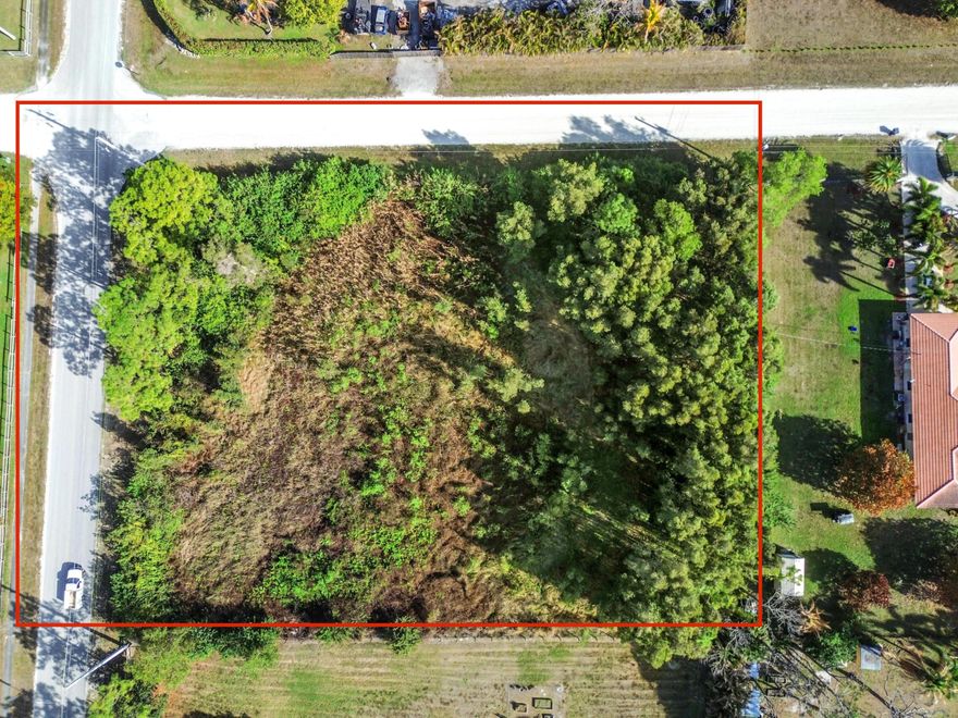 This exceptional vacant property stands out as a sprawling, high-and-dry corner lot, offering a rare blend of expansive space and natural beauty. This varied landscape provides the ultimate versatility; you can position your new home to capture wide-angle views of the neighborhood while maintaining a thick, verdant buffer for maximum privacy. With paved road access on two sides and a clean, rectangular footprint, the logistical possibilities for grand circular driveways and detached outbuildings are virtually limitless. Located in a peaceful residential pocket characterized by large-acreage estates and custom-built homes, this property offers a front-row seat to one of the area's most promising growth corridors. The aerial views reveal a neighborhood that prizes quiet, country-style living without sacrificing connectivity, as evidenced by the well-maintained road networks and nearby utility infrastructure. Whether you are an investor looking for a prime piece of real estate or a homeowner ready to break ground on a private sanctuary, this lot delivers the perfect foundation. Embrace the freedom of no HOA restrictions and the luxury of having enough room for a pool, workshop, and a flourishing tropical garden.