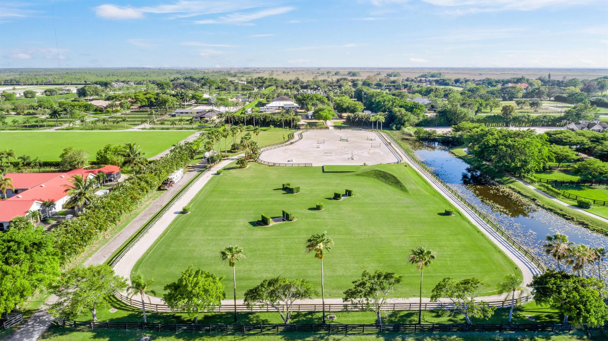 Equestrians dream farm on 10 AC (2 five acre lots) with large all weather arena and spacious Grand Prix field with bank and water jump. This scenic farm features 24 stalls, a new reverse osmosis water system, a 6 horse MK walker and 14 paddocks. There are 4 bedrooms for staff located by the barn, as well as a separate home with 4 bedrooms and 3 full baths plus a large screened porch and pool. Plenty of room to train your horses and great potential for leasing stalls as there are 3 separate barns, camper hook ups and room for a large tent. This farm is popular and desirable as a place to spend the winter season, as there is plenty of room to train paired with first class equestrian facilities.