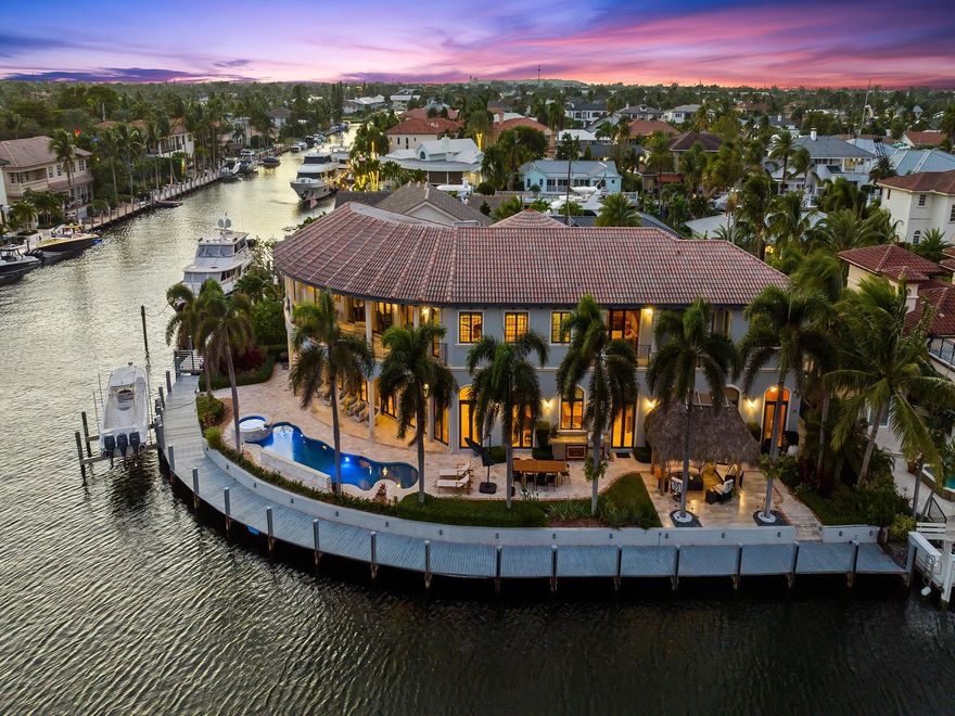 Discover this exquisite Southeast Point home on the South Grand Canal, three blocks from the Intracoastal and a quick trip to the Atlantic Ocean. An impressive 194' of water front, dockage, and a 16,000 lbs boat lift, this property is perfect for water enthusiasts. 8,407 sq. ft. of air-conditioned space within a total of 10,528 sq. ft. including 7 bedrooms and 6.5 bathrooms. Spacious 3-car garage boasts 11-12' ceilings and a whole-house water filtration system. The grand 24' foyer greets you by views of two canals and the pool through multiple French doors. The home is elegantly finished with crown molding and ample recessed lighting. The chef's kitchen has a large island, Subzero refrigerator/freezer, Wolf double convection ovens, 6-burner gas range & wine cooler. See Supplemental remarks