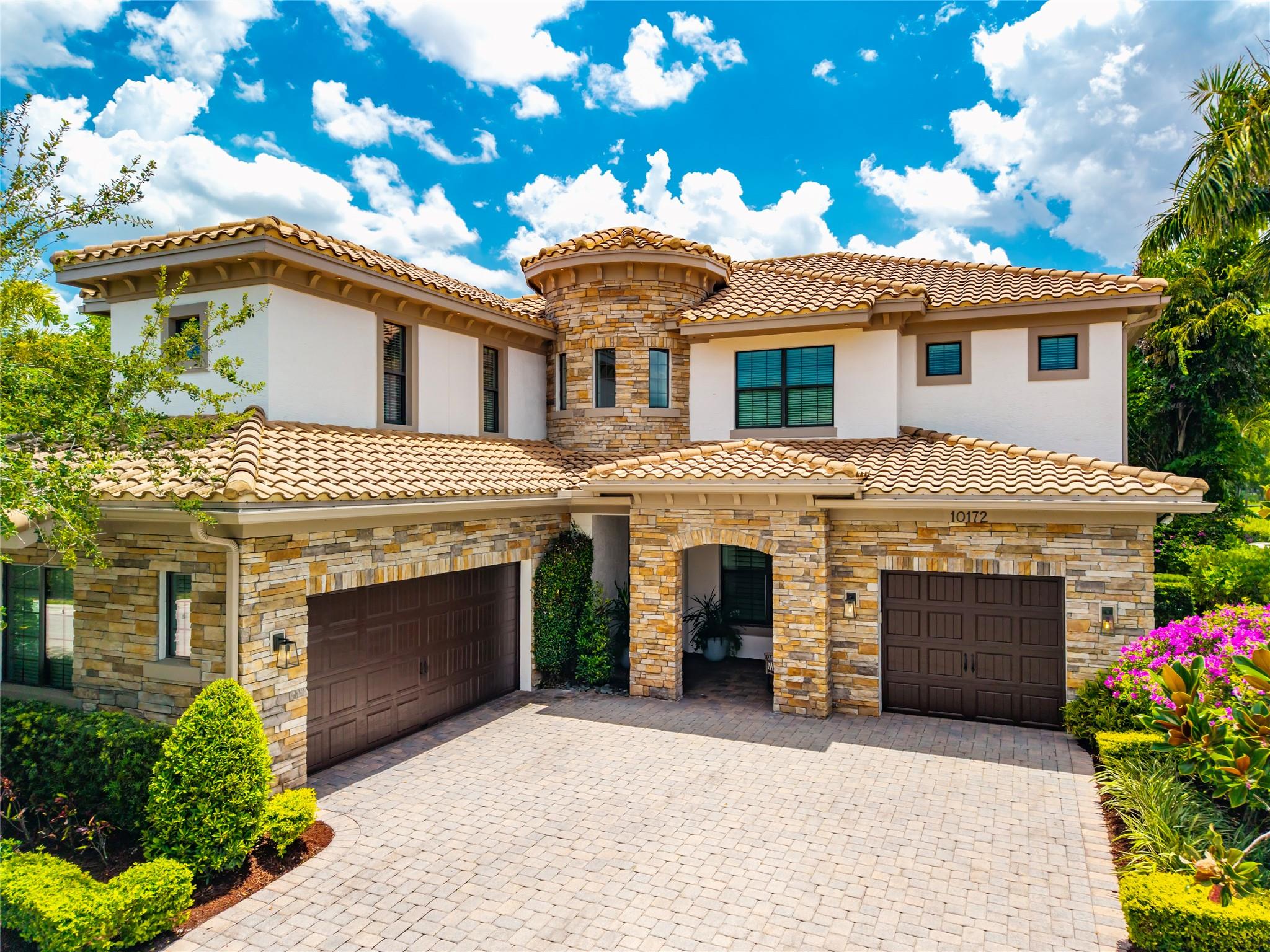 Nestled on the golf course & water in Parkland Golf & Country Club this exquisite home is an entertainers paradise with a heated, LED lighted pool & new summer kitchen. The 5BR/5.5BA/3CAR is a masterclass in luxury with a meticulously designed living space, custom closets & marble floors. The open plan includes a gourmet kitchen with Sub-Zero refrigerator, propane cooktop, large center island & hosting-style bar with ice machine. The master bedroom is its own sanctuary with office, balcony & a spa inspired en-suite. Control4 with speakers throughout, custom lighting features, security system, impact doors & windows and fenced professionally landscaped yard with mosquito misting system are just a few of the many upgrades included in this Bolano model. Continued in broker remarks.