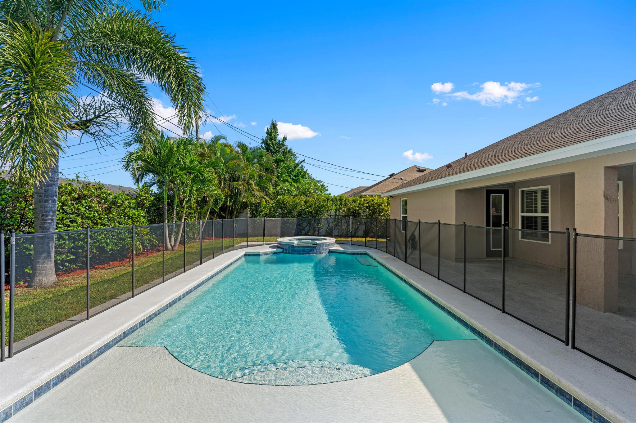 This one checks the boxes! Luxury, space and tropical paradise. With 4 bedrooms and a separate den, soaring 10 ft ceilings in the main areas and 3 full bathrooms, you are immersed in ample space for any family. Some features include granite counters and tile throughout, stainless-steel appliances, and plantation shutters that let in a beautiful amount of natural light. A covered lanai flows seamlessly to the gorgeous pool deck, with a cabana full bath for resort style living. The 2018 installed pool, is both heated and cooled, adjoined to the jacuzzi waterfall that has air jets for relaxation at day or night.From the fully fenced in backyard to the privacy plants along it, make this paradise home yours today!
