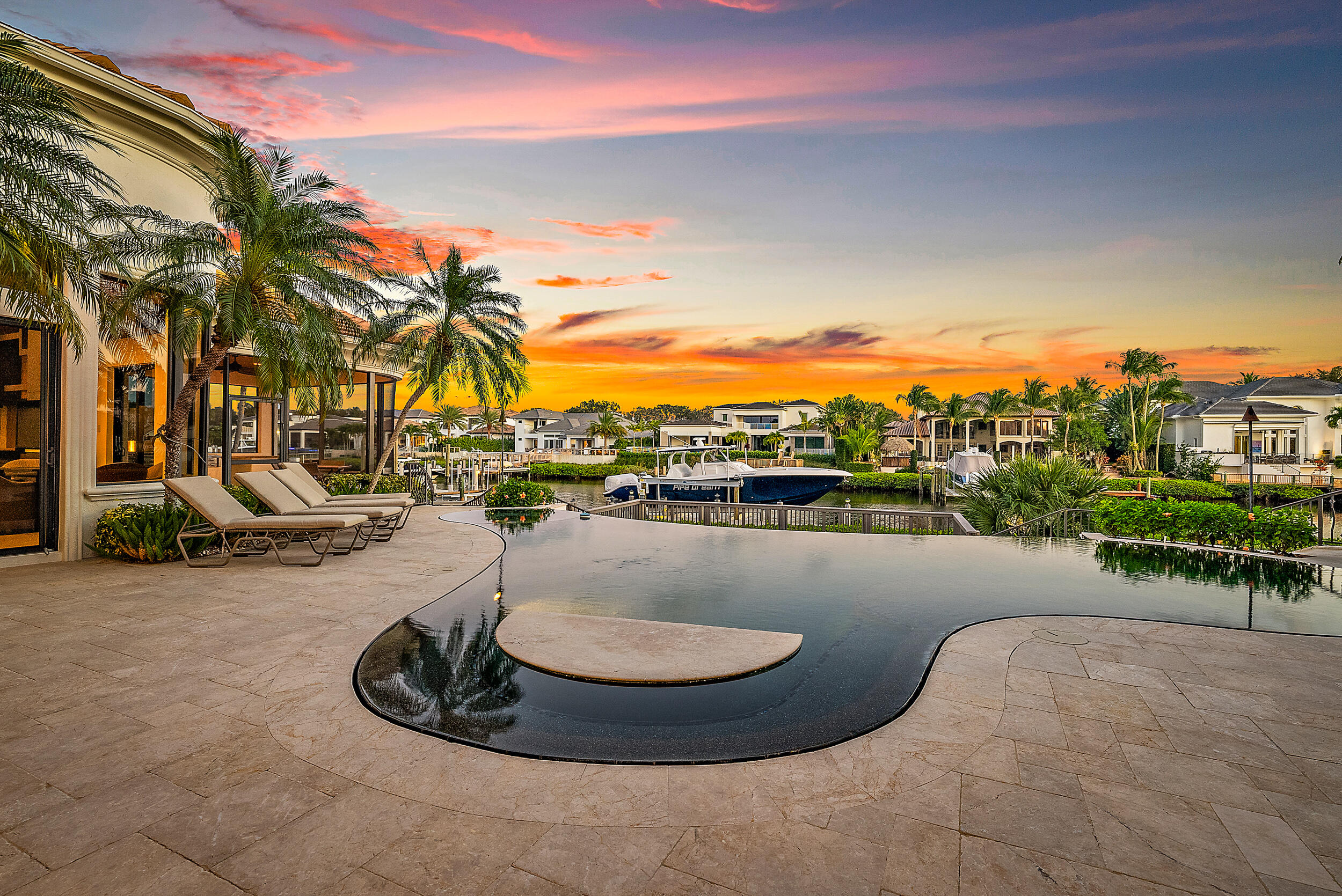 Waterfront Estate Home in Prestigious Admirals Cove. This home boasts 5 bedrooms, 5.2 baths, private location on quiet cul-de-sac, close to the front gate and Club and all amenities. The luxurious Primary Suite features a large sleeping room with views of pool and patio, laundry room, 1.5 baths, separate sitting/office and custom decorated walls. 3 additional en suite bedrooms on main floor. There is also a 2 room suite upstairs that can be a private retreat or Club Room. Plenty of room for entertaining in several areas; dining room, living room with wet bar that extends to the outdoors and the family room that is open to the kitchen. Chef's kitchen with 2 stone and wood islands, gas cooktop, and stainless appliances all open to the family room and easy access to the pool, patio ....