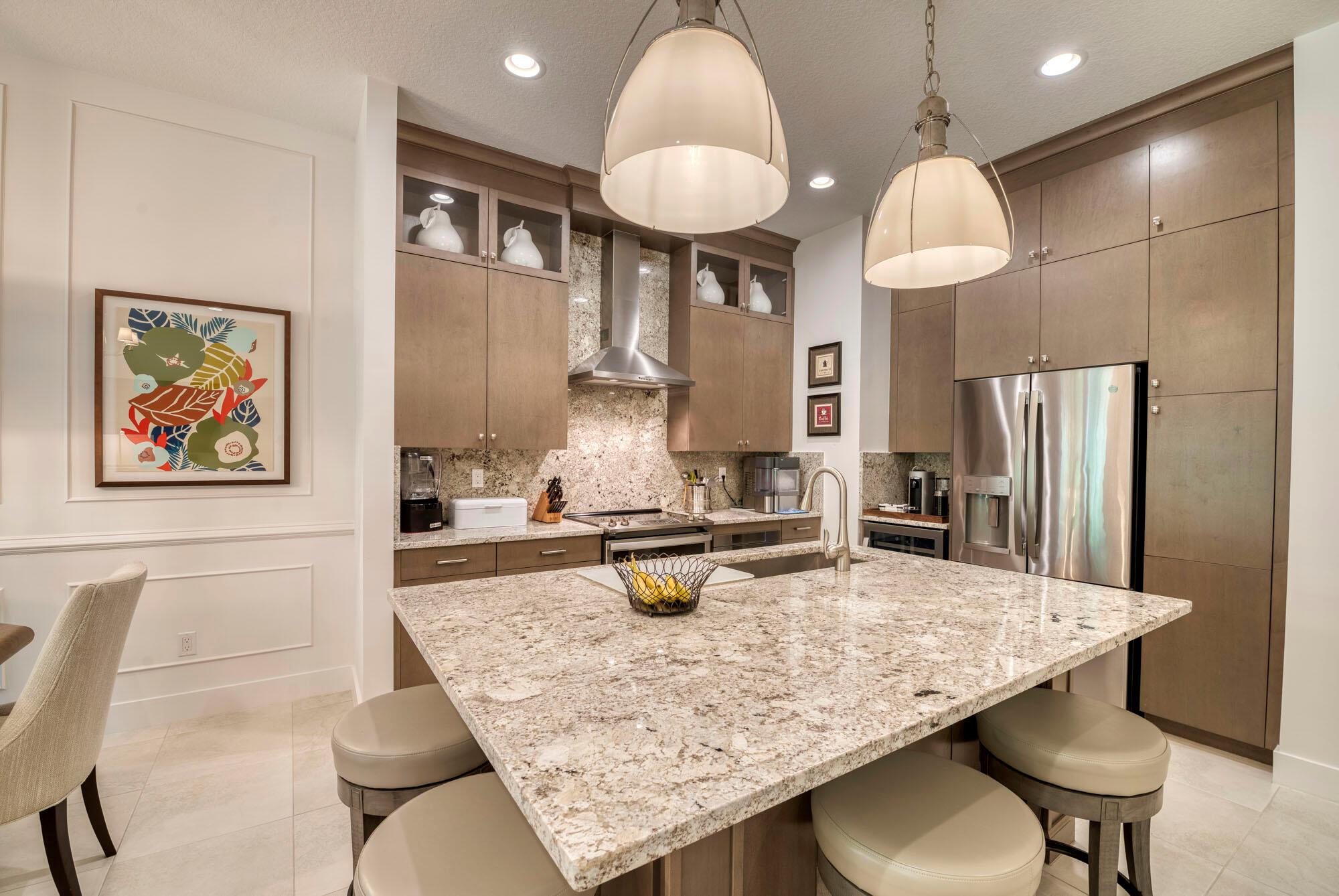 This beautifully appointed 3 bed, 3 bath townhome features a stunning open floor plan with gorgeous preserve views, and an unbeatable location just steps away from numerous dining and shopping destinations. The exquisite attention to detail can be seen from the moment you enter, with volume ceilings, intricate wall detailing, custom light fixtures, beautiful tile flooring, and upgraded cabinets and countertops.The main living area is bright and open, with floor to ceiling sliders that provide direct access to the private patio overlooking the preserve. Upstairs you'll find a spacious loft area and sizable bedrooms all with walk in closets. The primary suite enjoys breathtaking views, large custom closet, oversized walk in shower, dual vanities, and beautifully tiled floors. Located in the