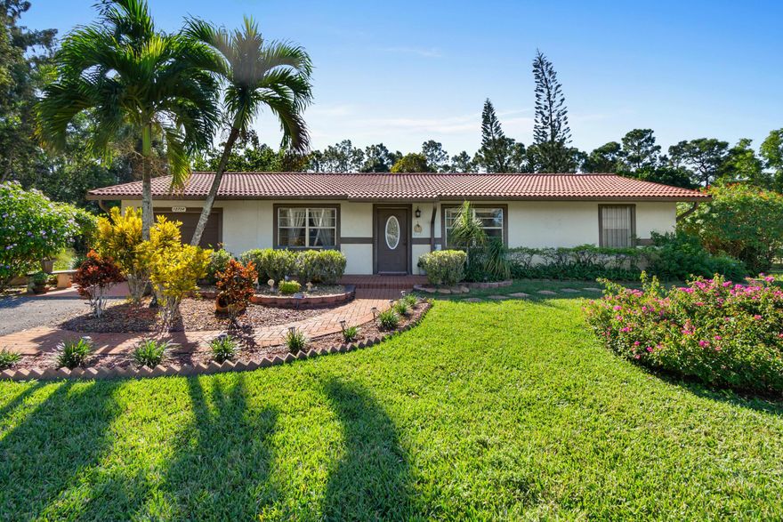 This adorable home has so much charm and curb appeal and situated on a paved street. Gorgeous  1.33 acre lot that is fully fenced with beautiful landscaping and huge storage shed. Nice open floor plan with oversized screened covered patio and additional open patio with paver walkway, huge laundry room with bonus storage room that could be home office. Newer septic tank (2019), newer washer, dryer and stove. Central AC and water heater replaced in 2018. Split bedroom plan with large master bedroom, living room and family room.