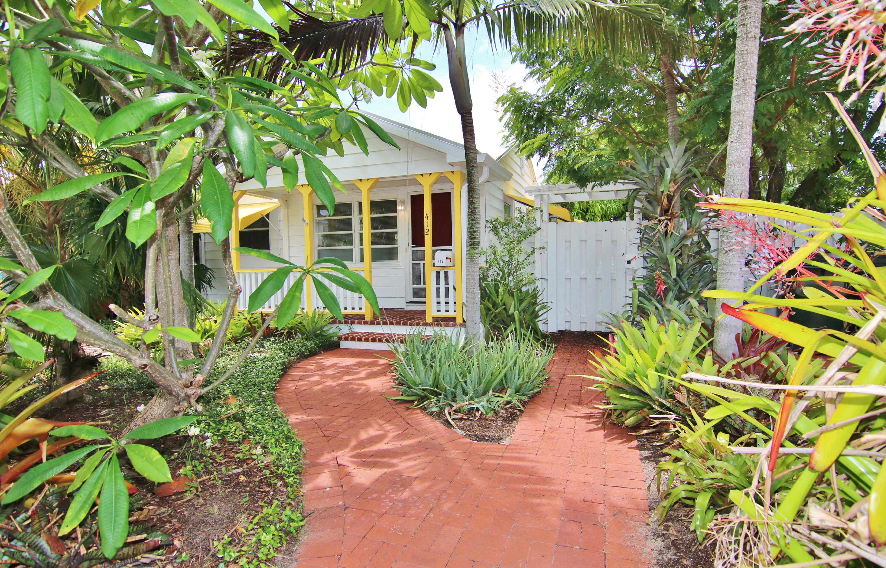 This Fresh and Clean Metal Roof Cottage features 2 Bedrooms, 1 Bathroom, Central A/C, Very Large Living room and kitchen, beautiful wood floors, covered porches, laundry area, whole house ventilation system, close to beach and downtown activities. (2 car garage available for storage) This is one of "The Cottages of Lake Worth" cottage