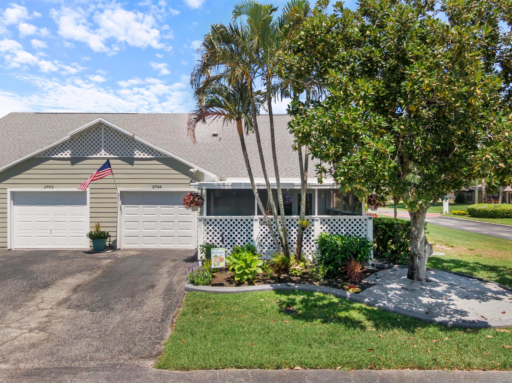 Discover this beautifully maintained 2BR + loft, 2BA, 1CG villa on a corner lot in quiet, desirable Tropical East. This home shines with natural light, vaulted ceilings, and an open floor plan. Features include a NEW roof (2022), NEW A/C (2025), impact windows (2015), NEW hurricane-rated garage door (2023), NEW water heater (2023), fresh interior and exterior paint, and professionally cleaned tile/grout (2023), Lanai was resealed (2025). Tile throughout living areas, and wood-look plank tile in bedrooms. The kitchen offers 42'' wood cabinets, granite counters/backsplash, stainless appliances, and a breakfast island. Owner's suite has a nice walk-in closet, updated vanity, and tiled shower. French doors lead to your covered lanai, perfect for outdoor living and entertainment