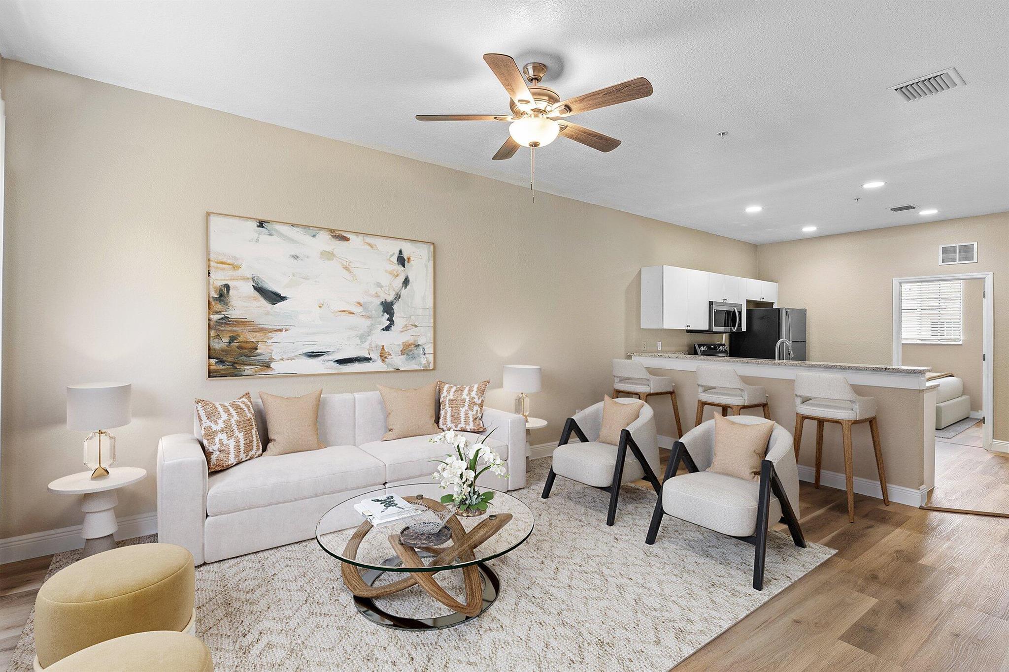 Discover the charm of this renovated 3-bedroom, 2-bathroom coach home in vibrant Marsh Harbour, close to the beach and shopping in Riviera Beach. Perfect for investors, this residence blends comfort and functionality for modern living. The spacious layout features a welcoming living area for relaxation and gatherings. The kitchen is thoughtfully designed for culinary ease with ample preparation space. New laminate wood flooring throughout creates an inviting atmosphere. Part of a guard-gated community, enjoy privacy, security, and amenities like a pool, spa, exercise room, tennis courts, lake paths, clubhouse, and playgrounds. Ideal for a balanced and fulfilling lifestyle!
