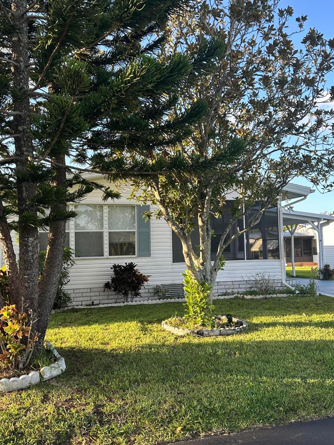 Beautiful home recently freshened up with flooring, paint, newer kitchen, large living area, eat in kitchen, Florida room, screened porch, dual sinks in master bath, large carport, shed and backs to a lake.  Ready to move in to, don't miss it.  All information is approximate and buyer is to verify all.