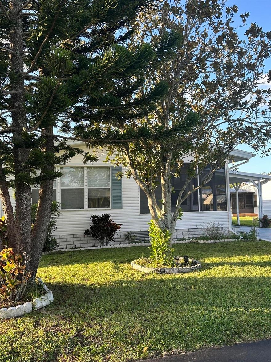 Beautiful home recently freshened up with flooring, paint, newer kitchen, large living area, eat in kitchen, Florida room, screened porch, dual sinks in master bath, large carport, shed and backs to a lake.  Ready to move in to, don't miss it.  All information is approximate and buyer is to verify all.