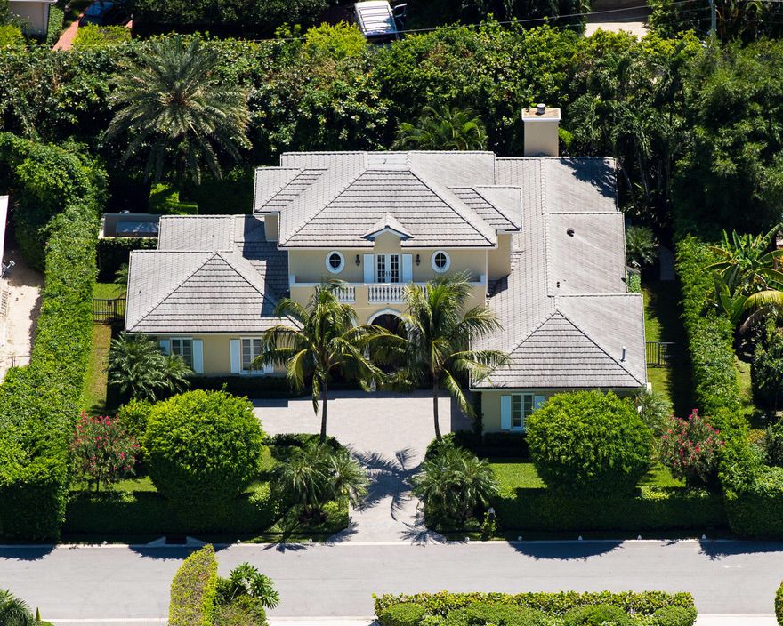 Beautiful British Colonial home built in 2003 with 5 bedrooms and 5 and a half baths. Welcoming motor court leads to covered entryway and 2 car garage. Classic tropical landscaping surrounds the property. Columned loggia with BBQ overlooks swimming pool. Fantastic chef's kitchen with top-of-the-line appliances and eat-at island leads to Great Room with fireplace. Kitchen and Great Room feature checkerboard marble flooring. Oversized Master Suite with dual baths and closets, terrace, and Juliet balcony. Full house generator.