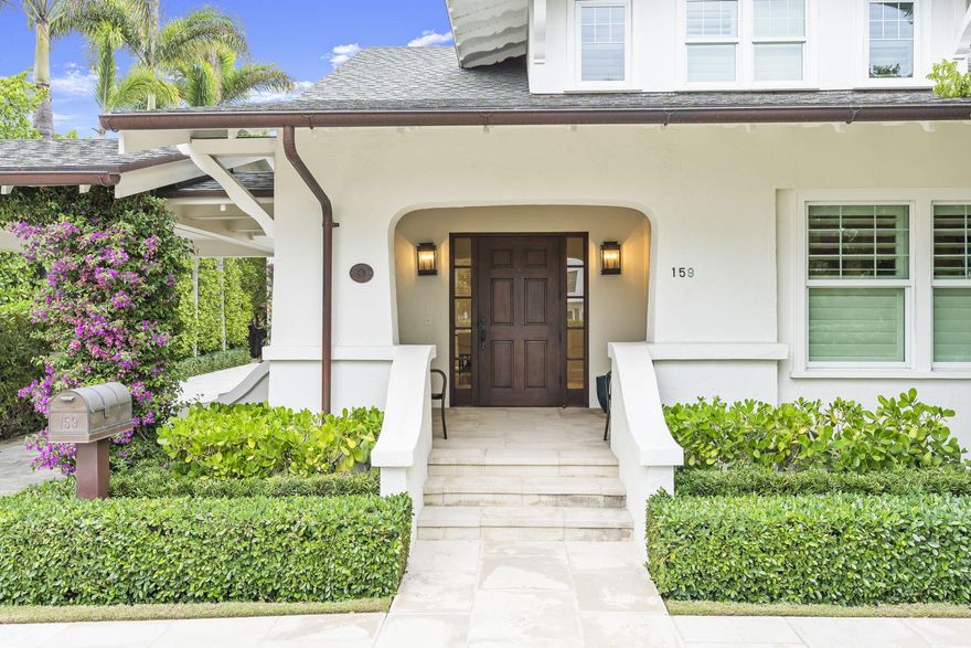 Move in ready ocean block home with master on the first floor opens to a private backyard with beautiful pool and gardens.  Bougainvillea blossoms adorn the porte-cochere leading to the charming entry porch. Inside, a welcoming foyer with a window seat and custom built-ins leads you to the formal living and dining room. The home is replete with pristine hardwood floors throughout, all new kitchen and bathrooms, full impact glass, and a first floor primary suite. Upstairs are two more guest bedrooms and a bonus room that would make a great home office or den. Attached to the main house by a breezeway is a 2 car garage with an exercise room, utility/laundry room, and a second story guest cottage with two bedrooms and bathrooms, and a living room.