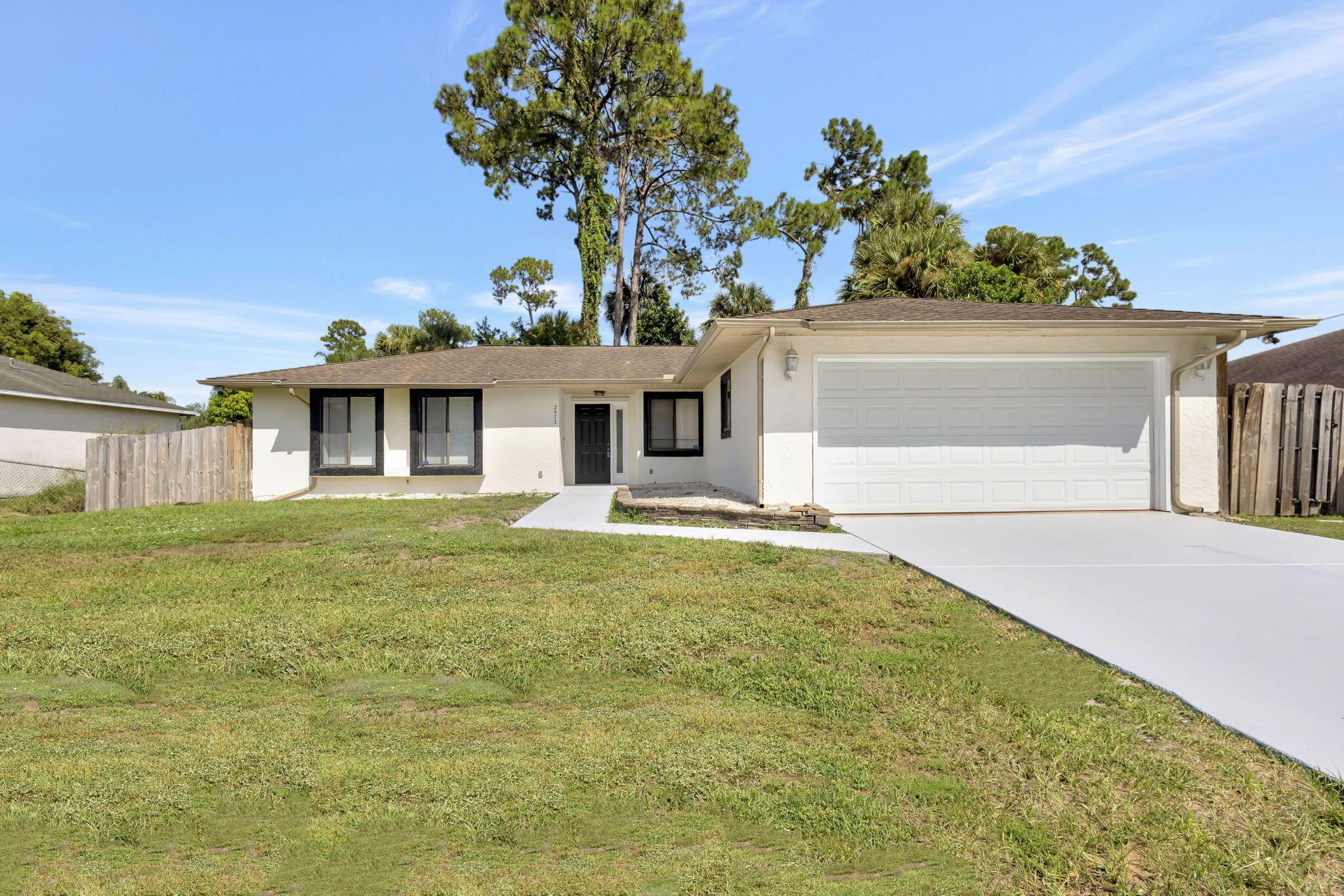 **NEW ROOF** with accepted offer, **NO HOA**, and a .24-acre lot in one of Port St. Lucie's most desirable areas! Bring your boat, RV, or extra vehicles to this 3-bedroom, 2-bath, 2-car garage home offering 1,428 sqft of living space. New A/C in 2021, including all new ductwork. LVP flooring throughout. Enjoy a spacious, fenced backyard--perfect for a pool. Pick Avocados from your own tree! A large screened patio is ideal for relaxing or entertaining. Just minutes to top-rated schools, shopping, dining, and major highways. Only 10 minutes to Tradition and Cleveland Clinic, and less than 30 minutes to the beach. Move-in ready and full of value--schedule your private tour today!