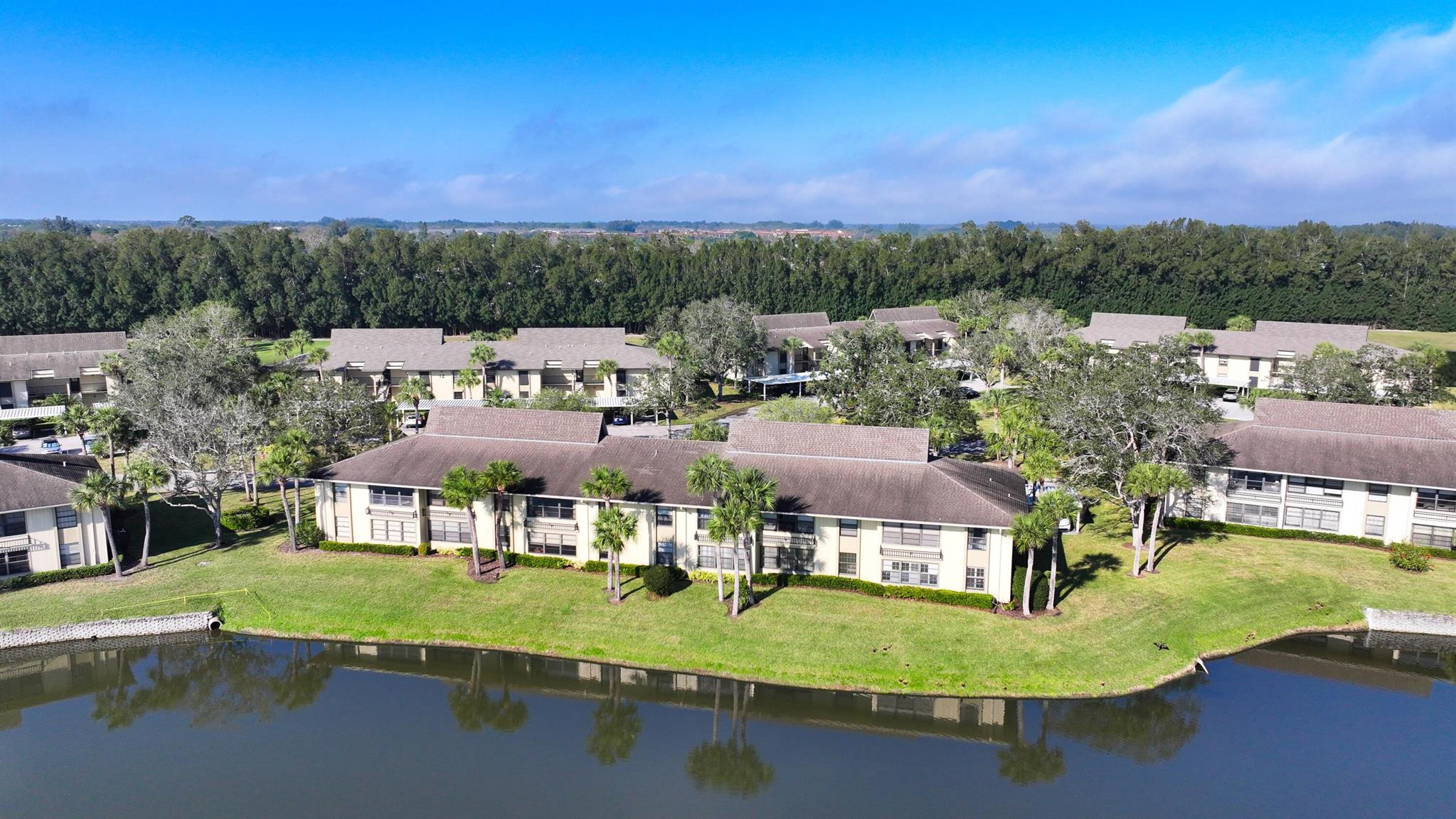 Wow, what a view!!! Spacious 2nd floor, 2 bedroom / 2 bath unit with wide scenic views of the 18th hole, lake and an assortment of wildlife. Spacious unit with large primary suite w/WIC, eat in kitchen bar, living/dining combo, and convenient in-unit W/D. Located in vibrant 55+ community with resort style amenities: 2 heated pools, clubhouse, BBQ pavilion, pickleball, & tennis. 18 hole public golf course avl. for pay for play (not incl. in condo fees). Near shopping, dining, & easy access to I-95. Don't miss this opportunity to enjoy the best of Florida living!