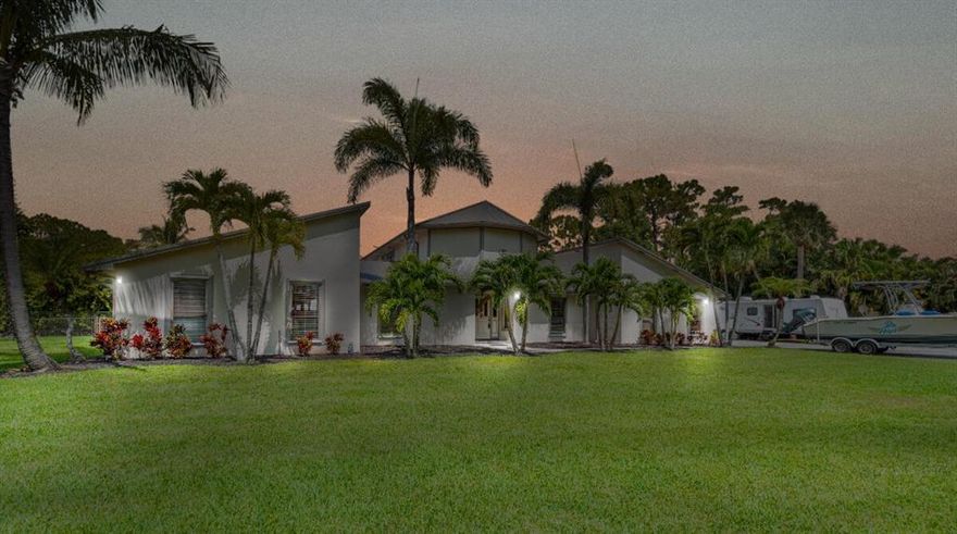 Prestigious Palm Beach Country Estates home on over 1 acre w/4bd 2ba 2 car garage 2 story home w/SEPARATE mother in-law suite which includes  1bd 1ba, full kitchen & living room!  Situated in the front section of PBCE, this spacious home features second floor private master suite w/dressing room/walk in closet & large bathroom.  First floor has 3bds w/large open kitchen, polished marble floors, formal dining, family room w/fireplace & utility room.  Lot has healthy turf lawn w/a few trees, plenty of room for pool.  Other features include new 2020 roof, A/C, appliances & drain field.