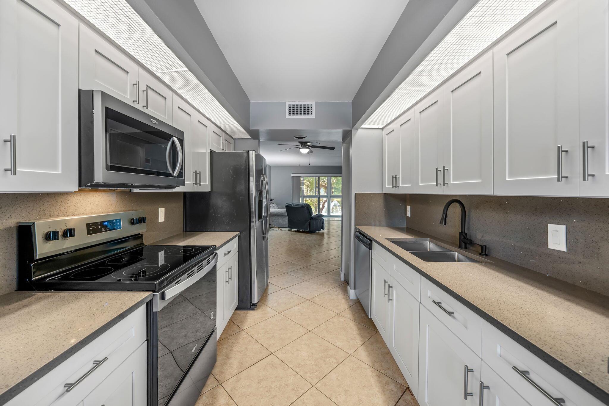 This beautifully updated, 2-bedroom, 2-bathroom condo is located in the sought-after Wynmoor community. It boasts a new stove and dishwasher, updated kitchen cabinets and counters, updated master bath, washer and dryer inside, and tile flooring throughout. Enjoy serene water views from the enclosed patio, perfect for morning coffee or evening relaxation. Located in a golf community with no high golf fees, residents enjoy numerous amenities such as free cable TV, bus service, $2 first-run movies, an on-site restaurant, pickleball, tennis, theater, dances, BBQs with DJ entertainment, billiards, a state-of-the-art fitness center, and more. Just 6 miles to Pompano Beach with shopping and dining options, this condo offers the ideal combination of comfort, convenience, and recreation.