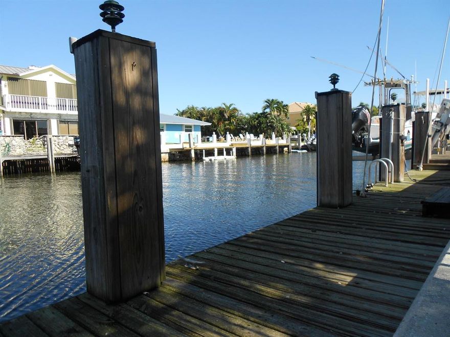 Fisherman and boaters paradise with 75' of direct waterfront and only 9 houses away from the intracoastal that leads to the inlet.  This solid home has so much to offer; boat dock, boat lift, salt water chlorinated pool system which has both heater and chiller, making the pool the perfect temperature year round.   The pool pump 1yr old. Pavered patio deck , retractable awning. Impact windows and doors were replaced in '04, roof '99 and a/c less than a year old.  The home is also wired for a generator.  Come and make this home your own slice of paradise.