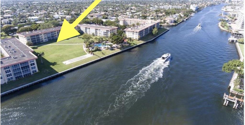 SPECTACULAR INTRACOASTAL VIEW in prestigious Lighthouse Point. Priced to sell, this impeccably remodeled huge one bedroom first floor unit won't last. 2BR units are only 80 sq. ft. more. Enjoy watching the boats go by from the living room or the breezy screened in porch with upgraded lower screen to keep debris out. The large grassy area feels like a beautiful backyard, perfect for entertaining guests, or entertain on your boat, with dockage available on site up to 44 ft. .Just steps from the beautiful pool and Clubhouse directly on the ICW, with community barbeques, or enjoy the first floor exclusivity of your own barbeque. Impact windows throughout, two large Master closets,(1 walk in) oversized hallway accomodates scriver's office area.