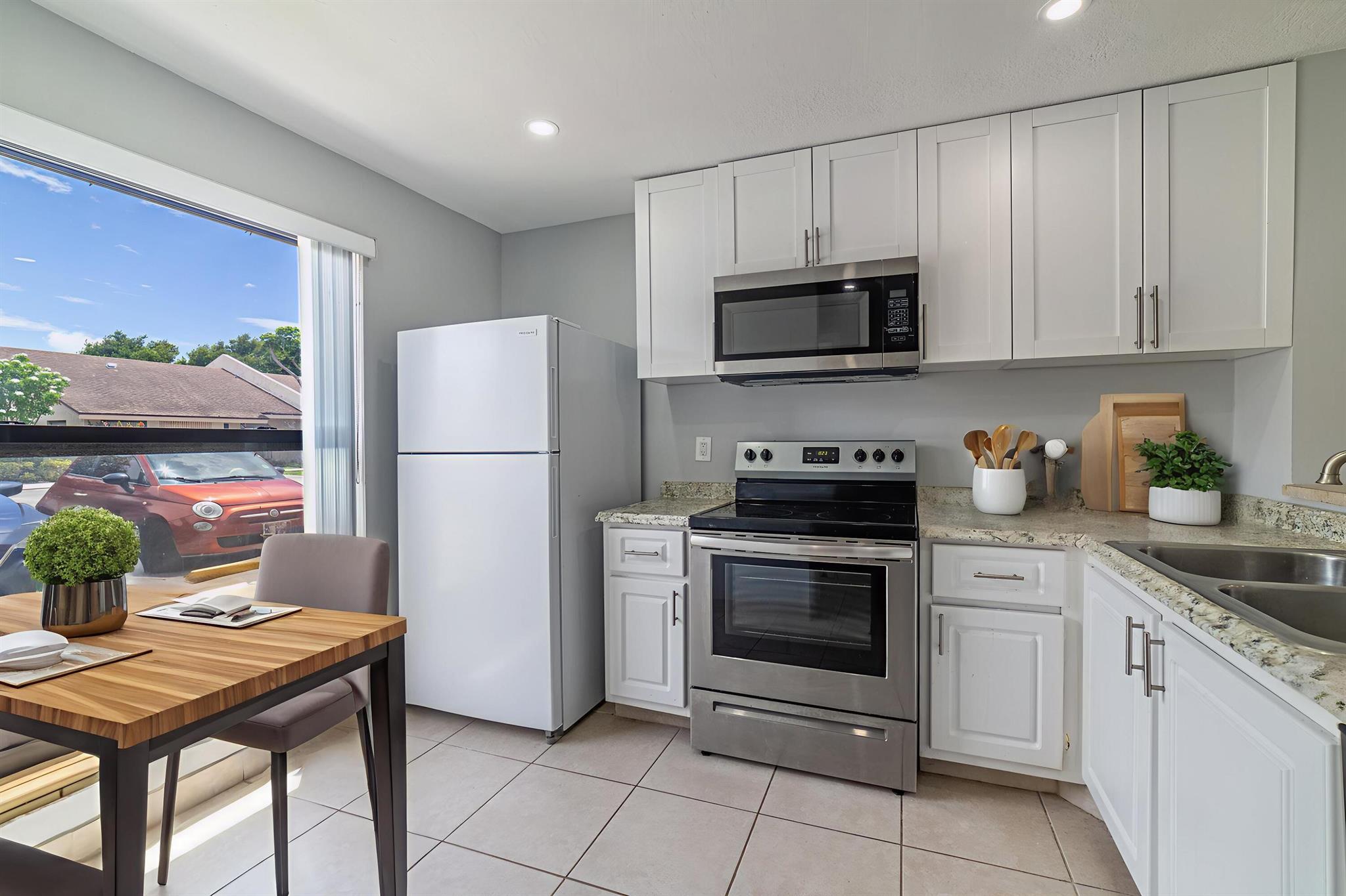 Located in a desirable neighborhood, this fully renovated 2-bedroom, 2.5-bathroom corner townhouse is perfect for those looking to enjoy all that Florida has to offer. Step inside to a bright open-concept layout, freshly painted with tile flooring throughout. The kitchen features new stainless steel appliances, wood cabinetry. Each bedroom is a master suite, boasting a private bathroom and a walk-in closet. New A/C system, new water heater, in-unit washer and dryer, and brand-new impact windows and doors for enhanced security and energy efficiency. Water is included in the monthly rent. Step outside to a charming private patio -- the perfect spot to relax or host guests.