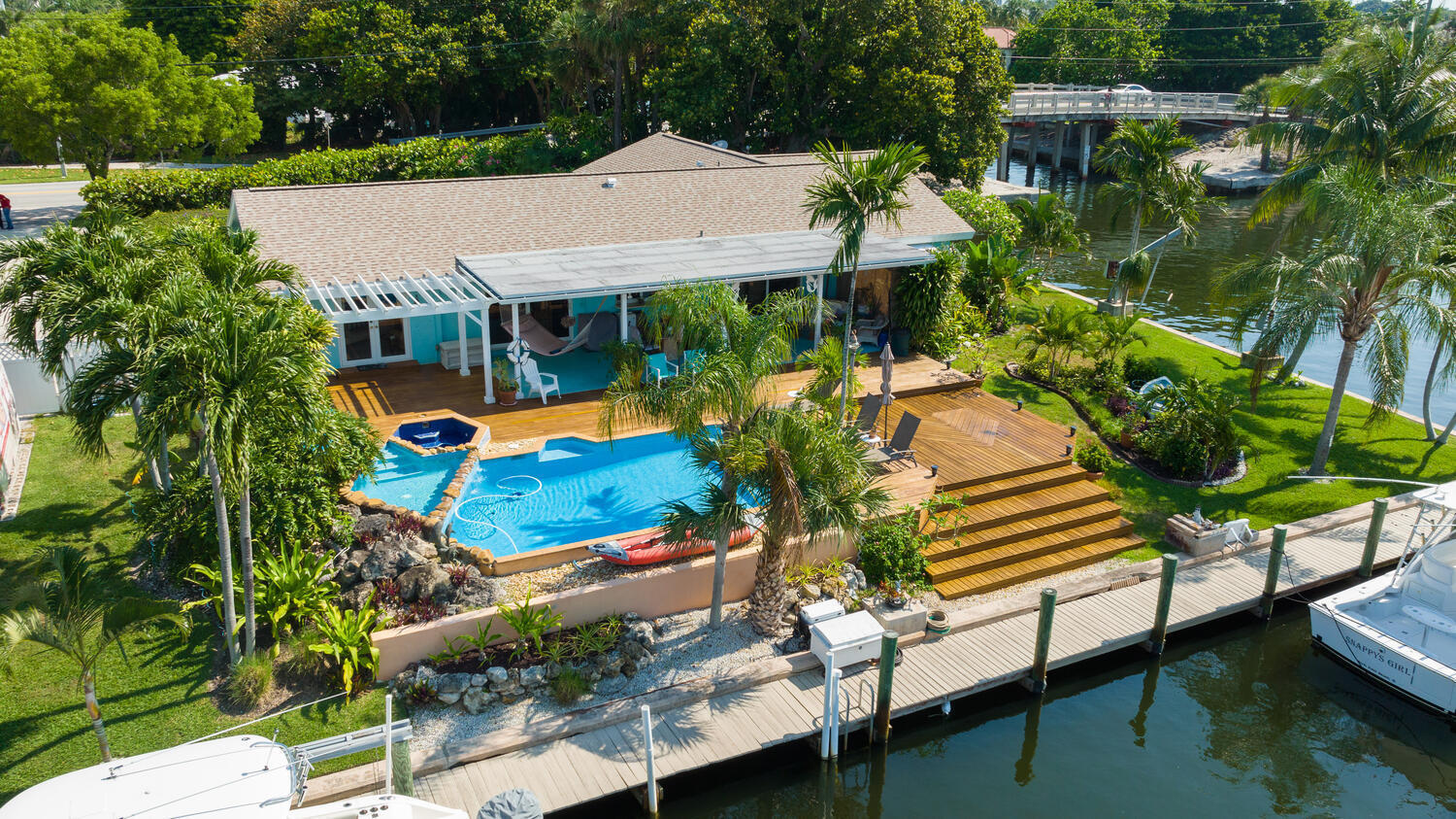 The Village of North Palm Beach is a highly sought after boater's paradise! This property offers 270 feet of waterfrontage on the Earman River and includes a 14k lb boat lift. The residence is 3 bedrooms and 2 baths with a 2 car garage. There is also a bonus 1 bedroom,1 bath, efficiency with it's own private entrance. The home has impact glass and doors .The roof, soffit and gutters were replaced in 2019 and both AC units replaced in 2021. The pool was redone in 2018 along with the deck. Great opportunity to own in North Palm Beach!