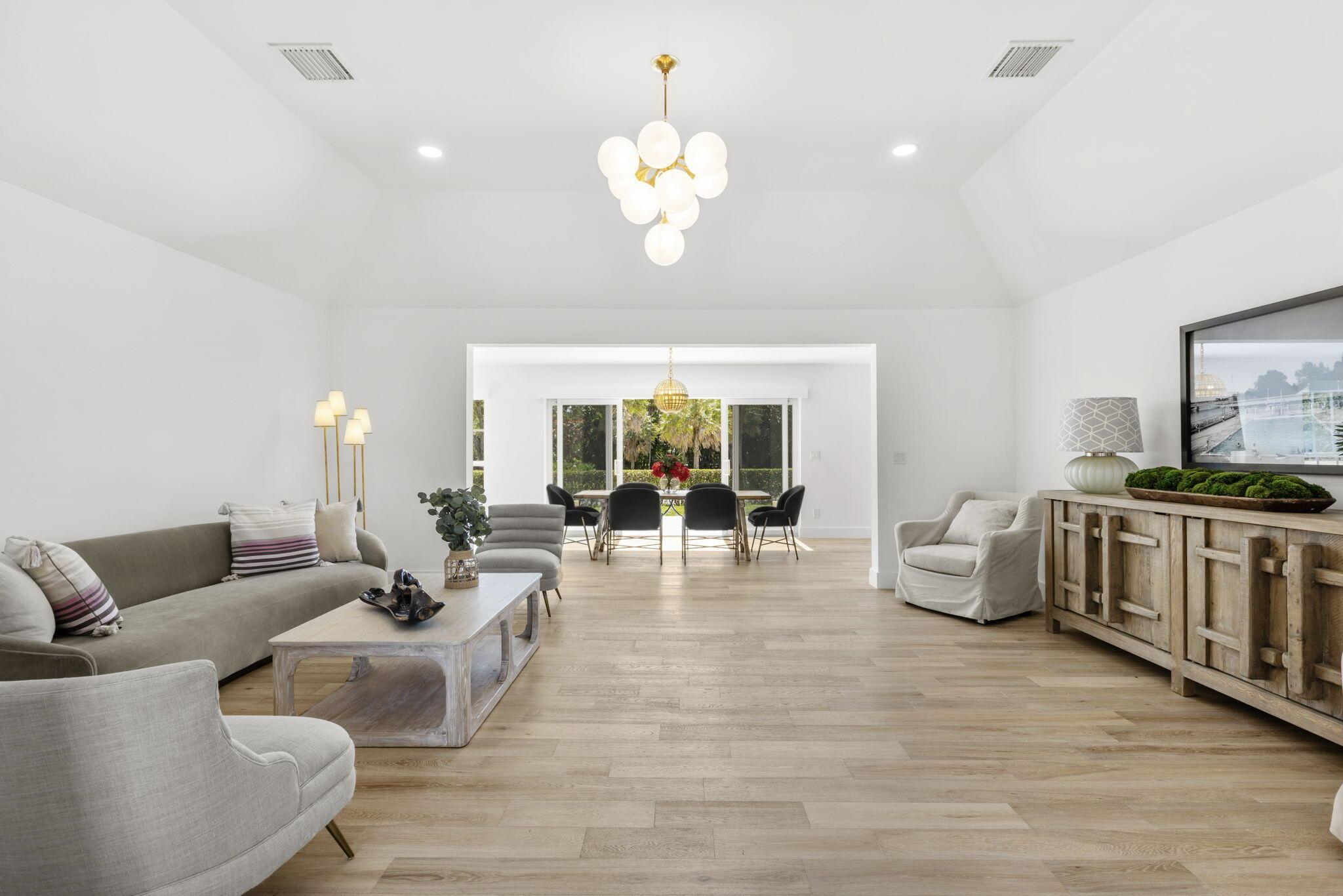 This timeless Bermuda style home is located in a expansive tranquil setting on Little Pond in prestigious Point Manalapan. A spacious three bedroom, three bathroom home completely remodeled inside and out by a top Palm Beach designer. A tastefully appointed interior features an inviting foyer with custom lighting, flowing to an open living and dining space filled with natural light complemented with wide plank blonde oak engineered wood floors, vaulted ceilings, custom lighting, and a wall of sliding glass doors opening to peaceful views of the yard and pond. A bright, beautiful kitchen with white shaker cabinets, custom quartz counters, designer lighting and Fulgor Milano appliances will inspire you. Three spacious split bedrooms with on-suite bathrooms allow room for​​‌​​​​‌​‌​​​‌‌​​​‌‌‌​​‌​​‌‌​​​​ guests.