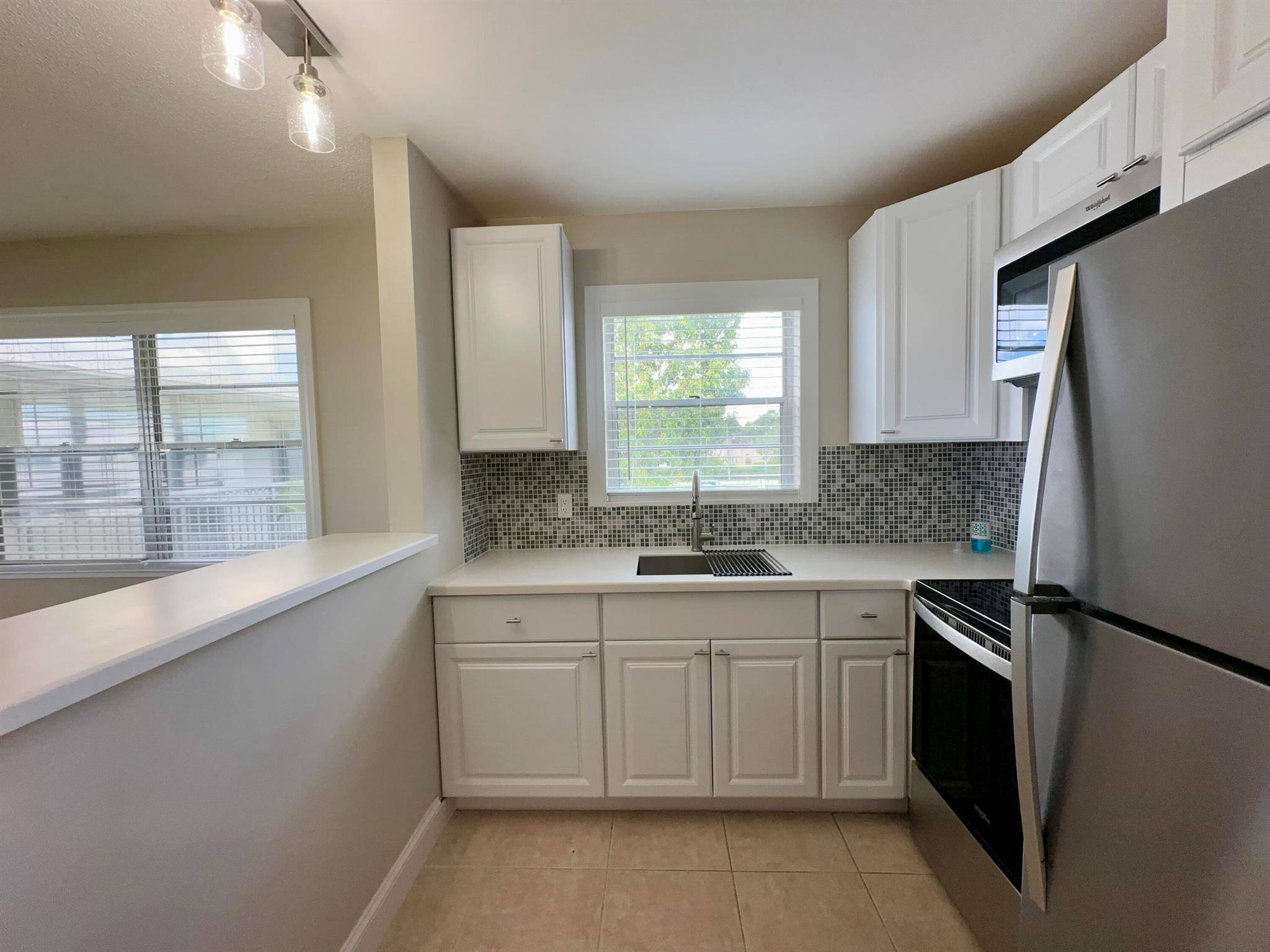 Beautifully Updated unit for rent In 55+ Century Village! MUST-SEE CORNER 1/1.5 With Central AC and Fantastic Location. Pretty Newly Updated Kitchen With White Cabinets, Stainless Appliances, Tile Backsplash, and Window Over Sink. Updated Baths. Neutral Tile Flooring Throughout. Designer Touches Include Wide Baseboards, Decorative Window Trim, Updated Window Treatments, and Updated Light Fixtures. Freshly Painted Throughout. Long Enclosed Lanai. PLEASE note this building has a Lift & a Second Floor Laundry. Beautiful Resident Patio! Fantastic Central Location Close to The Main Clubhouse and Hastings Fitness Center. Century Village is a 55+ Resort Style community with so much to offer...