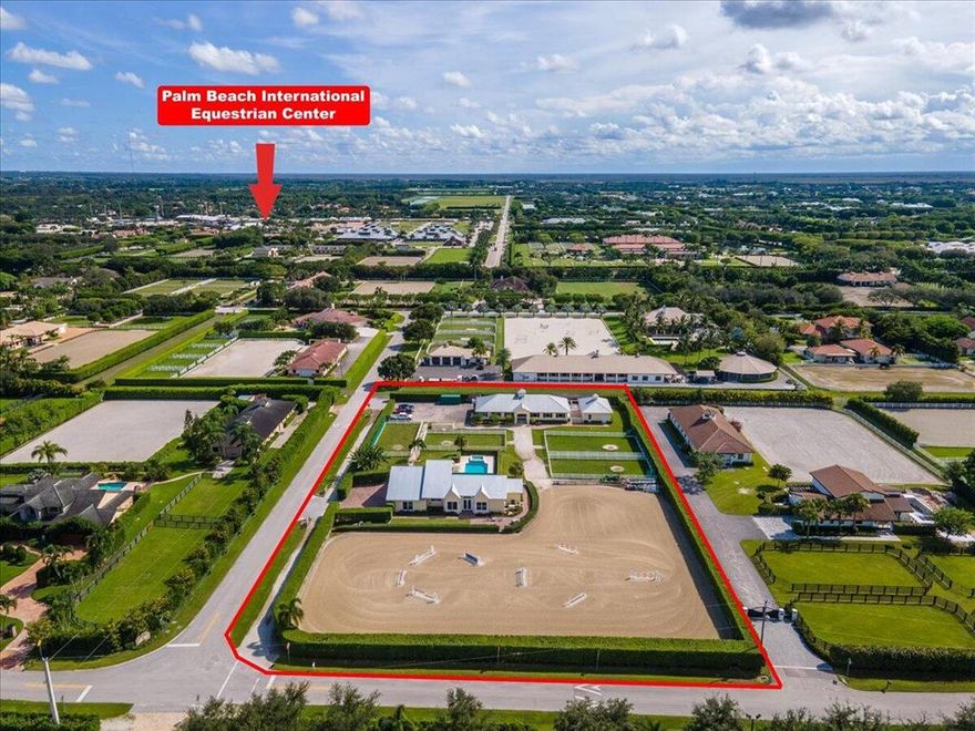 HACKING DISTANCE TO WEF! Featuring 4 bedrooms/3 full baths, metal roof, and impact glass. French doors open up to the large saltwater pool with propane heater. The barn is equipped with 11 stalls as well as an office, tack room, grooms quarters. Plenty of space 4 paddocks and an oversized ring with fiber and elastic footing (installed 3 yr ago) + 8 in drainage layer all situated on 2.4 acres. This is the Perfect Equestrian Property for an easy to maintain operation!