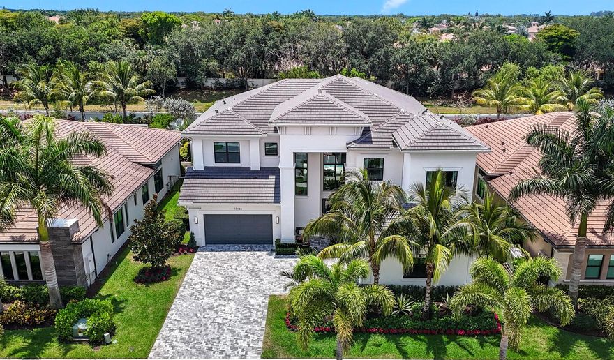 This Absolutely Stunning, Turnkey, Riverside Model Home is the most sought after model in all of Boca Bridges. Just bring your toothbrush and move right in! Live the ultimate country club lifestyle in this newly built 5 bedroom, 7 bathroom home encompassing almost 6,000 square feet of living space without the country club fees. Upon entering this spacious, open and inviting home, guests are greeted with beautiful, light colored, wide plank, wood floors and a grand 2 story entrance which leads you into a very large Great Room. Enjoy preparing meals in the adjacent gourmet, chef's kitchen, featuring a very large kitchen island with seating up to 5 and top of the line appliances including Subzero and Wolf. Enjoy entertaining guests and unwinding over dinner in the