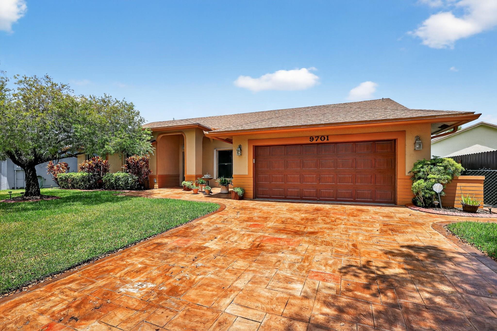 Welcome to 9701 Millpond Dr, a beautifully maintained home in the desirable community of Miramar. This spacious residence features bright open living areas, high ceilings, and a modern kitchen with granite countertops, stainless steel appliances, and a center island. The primary suite offers a walk-in closet and spa-like bath with dual vanities and a glass-enclosed shower. Enjoy your private backyard oasis with a screened patio, ideal for entertaining or relaxing amid lush tropical landscaping. Additional highlights include a two-car garage, updated flooring, fresh paint, and ample storage. Conveniently located near top schools, shopping, dining, and major highways.