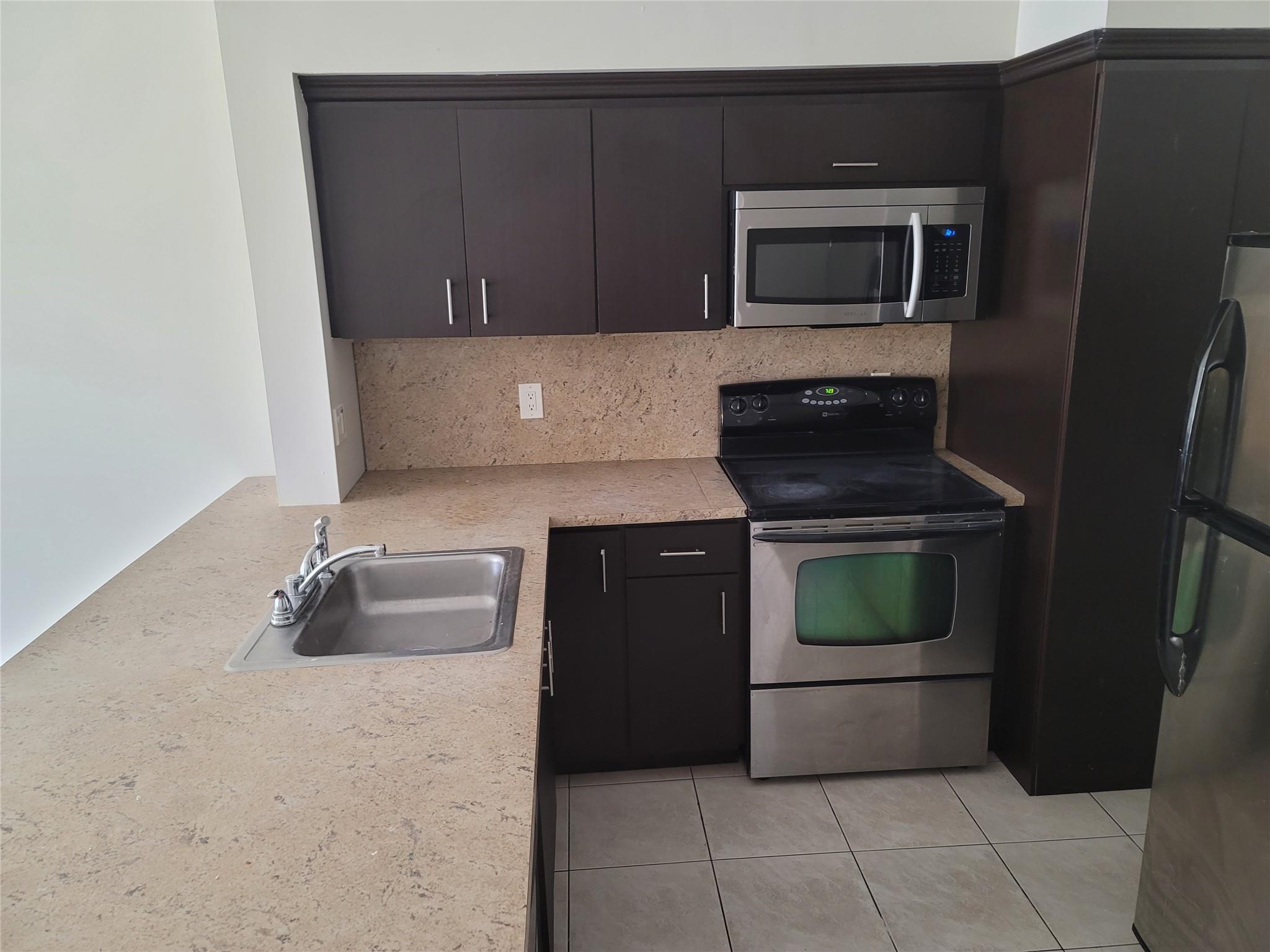 remodeled 2-1 in sunrise ,tile all over ,newer kitchen, stainless steel appliances ,screened porch close to schools and shopping
