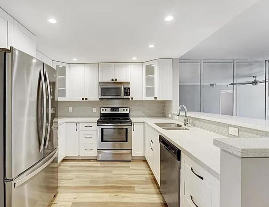 Beautifully Updated Corner Villa 2 bedroom, 2 bath in Boca Raton. Stylish, bright, and airy, this beautifully updated corner villa features an open split bedroom floor plan and a modern kitchen with quartz countertops, soft-close cabinets, and stainless steel appliances. Bedrooms and bathrooms have been nicely renovated.Enjoy the convenience of a one car garage and a lovely screened-in back patio, perfect for relaxing. Ideal for seasonal or year round living. This home is located in Town Villas, a premier 55+ community offering amenities: Clubhouse, pool, tennis courts, gym, billiards, library and several activities throughout  the year to enjoy. All just a short drive to the beach!